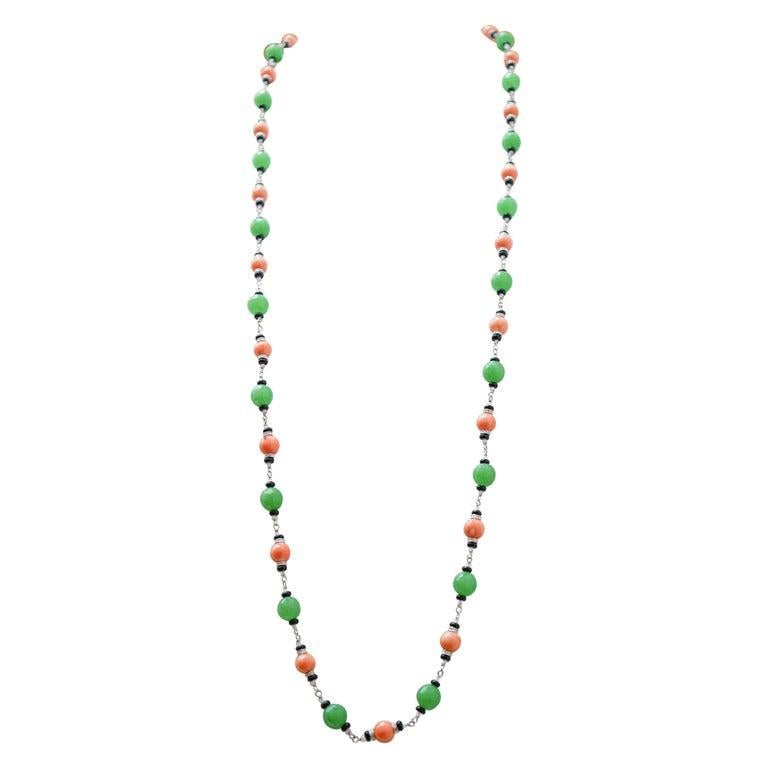 Amazing necklace in 9K white gold structure mounted with a sequence of coral, gold stuctures studded with diamonds, onyx, jade and rock crystal.
This necklace was totally handmade by Italian master goldsmiths and it is in perfect