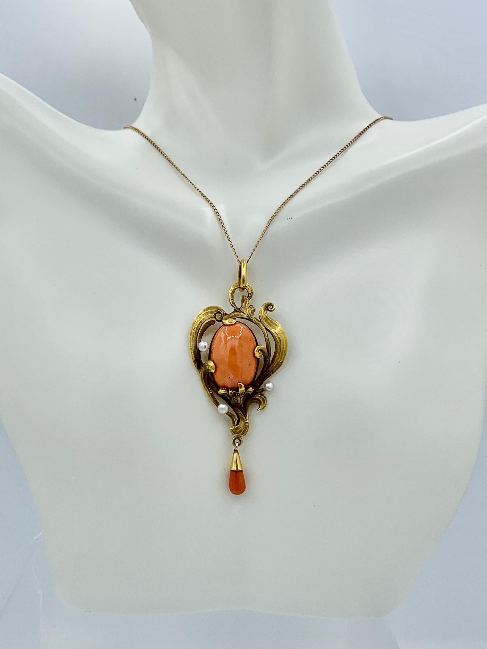 This is a stunning Museum Quality Antique Art Nouveau Coral and Pearl Pendant in an exquisite flower motif in 18 Karat Gold.  The magnificent coral Pendant dates to the Belle Epoque - Art Nouveau period, circa 1880 - 1915.  In the center is a