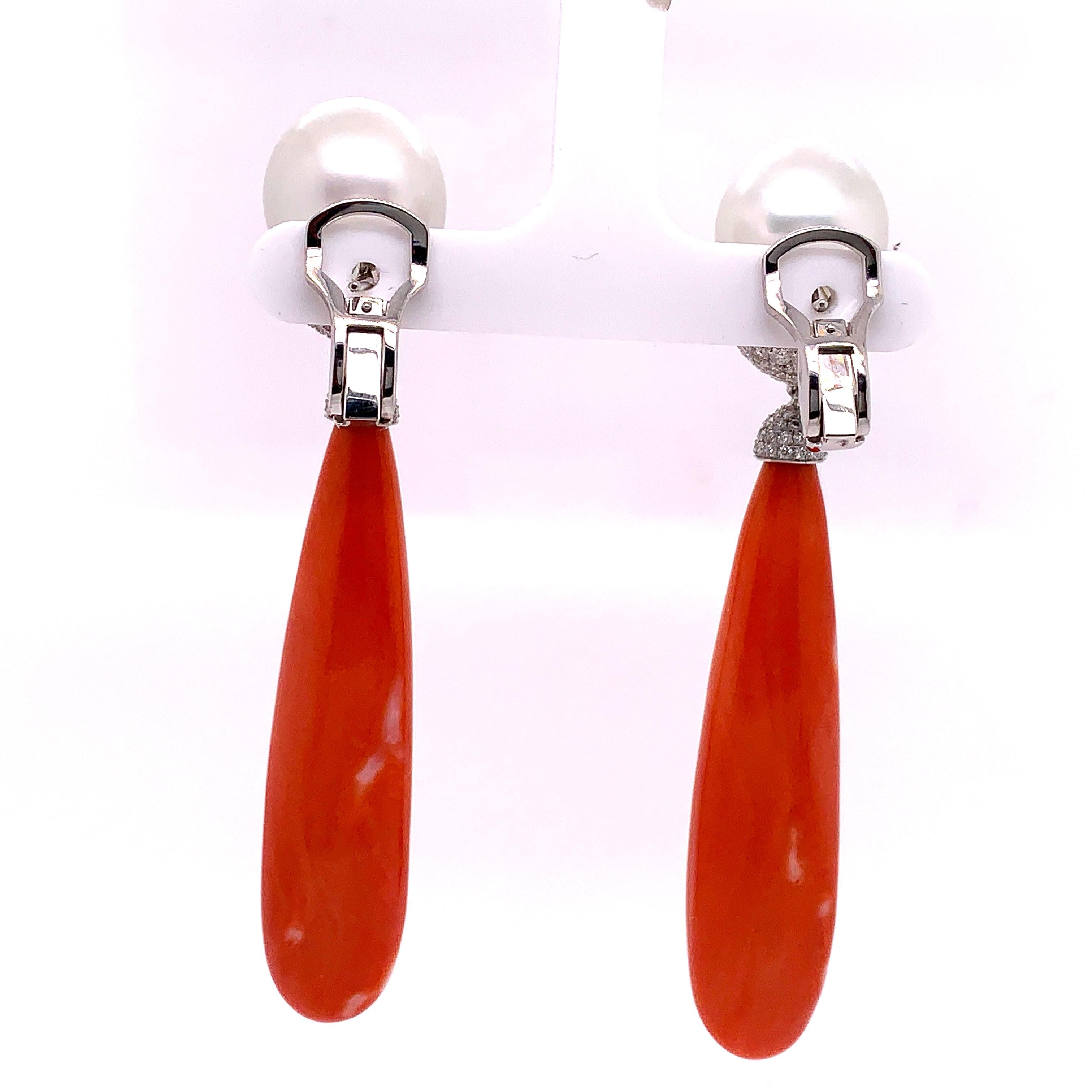 These unique coral and pearl drop earrings contain a pair of coral sticks with beautiful smooth and even color. Dangling from a pair of SOUTH SEA PEARLS (with measuremnets of 14.80-14.85 x 17.00mm and 14.35-14.40 x 17.95mm).

These natural oceanin