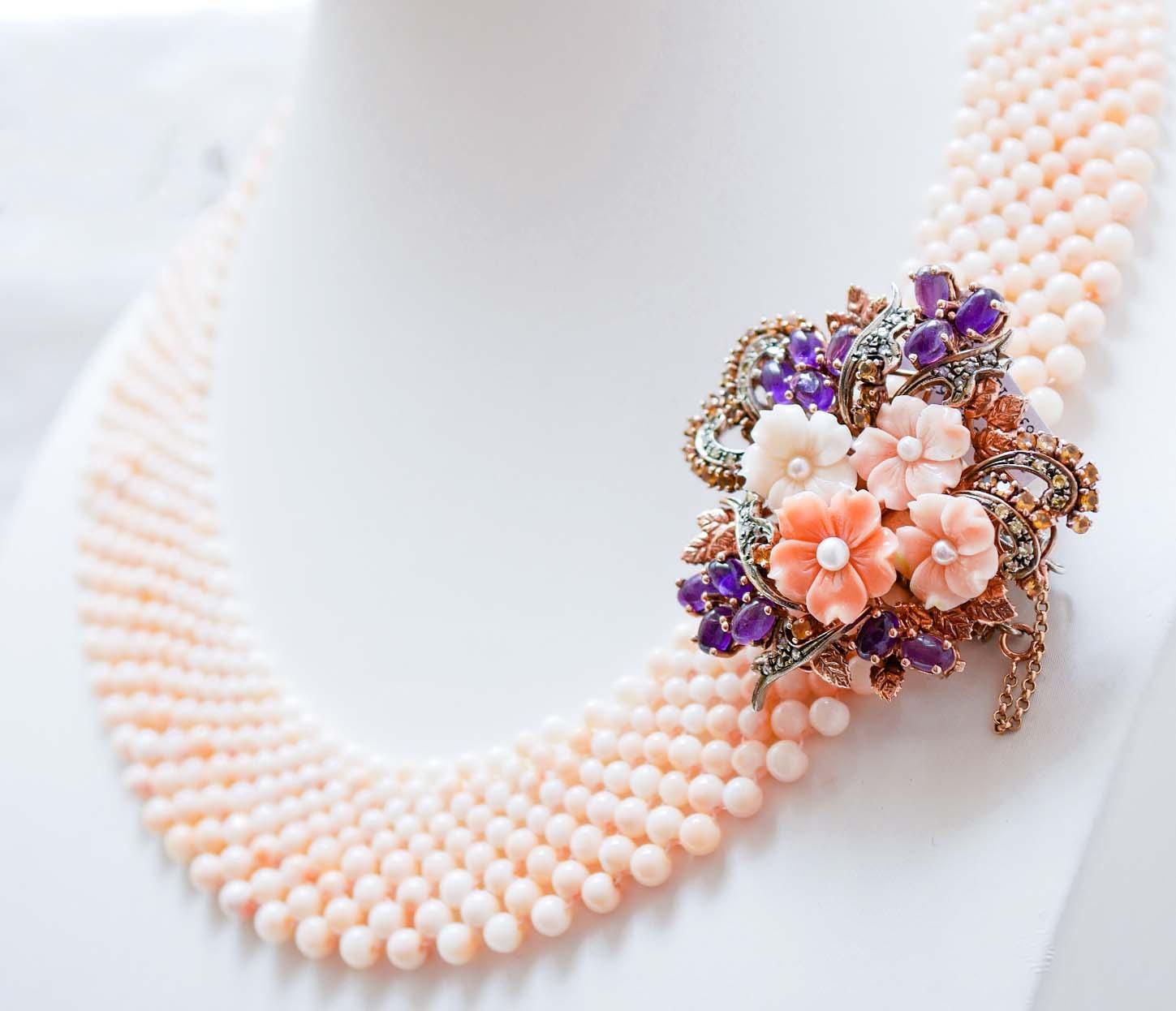 Fantastic necklace mounted with intertwined beads of coral and, as clasp, a structure in 9 kt rose gold and silver mounted with flowers of coral with a little pearl surrounded by diamonds, amethyst and topaz.
This necklace was totally handmade by