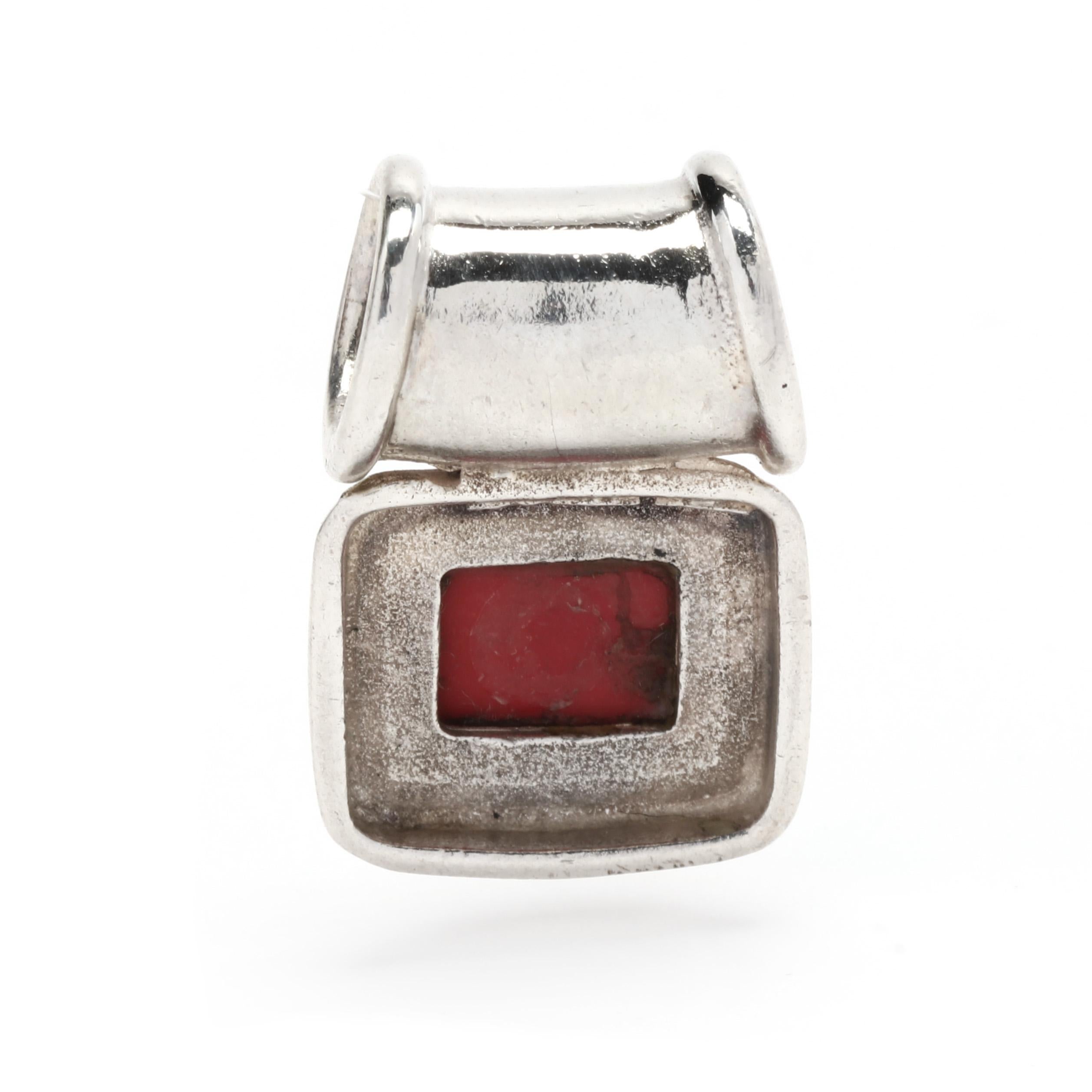 This beautiful and unique red coral pendant is crafted from sterling silver and set with a natural red coral stone. It has a length of 7/8 inch, making it perfect for everyday wear. The warm hue of the coral brings out the details of the intricate