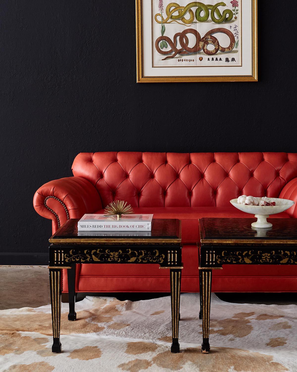 Fantastic tufted leather chesterfield sofa settee or loveseat featuring a stylish coral red leather. Deep generous seating area flanked by English style rolled arms with brass nail head trim accents. Constructed with a hardwood frame and upholstered