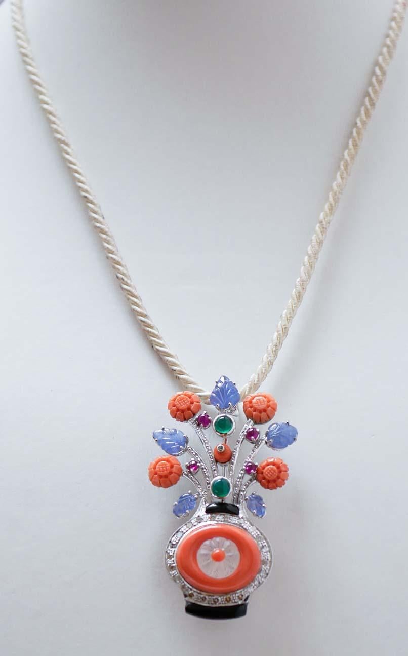 Fantastic basket shape brooch in platinum and 18 kt white gold structure mounted with sapphires, rubies, diamonds  and green agate in the upper part. The lower part is mounted with a rock crystal in the center of a coral surrounded by diamonds and