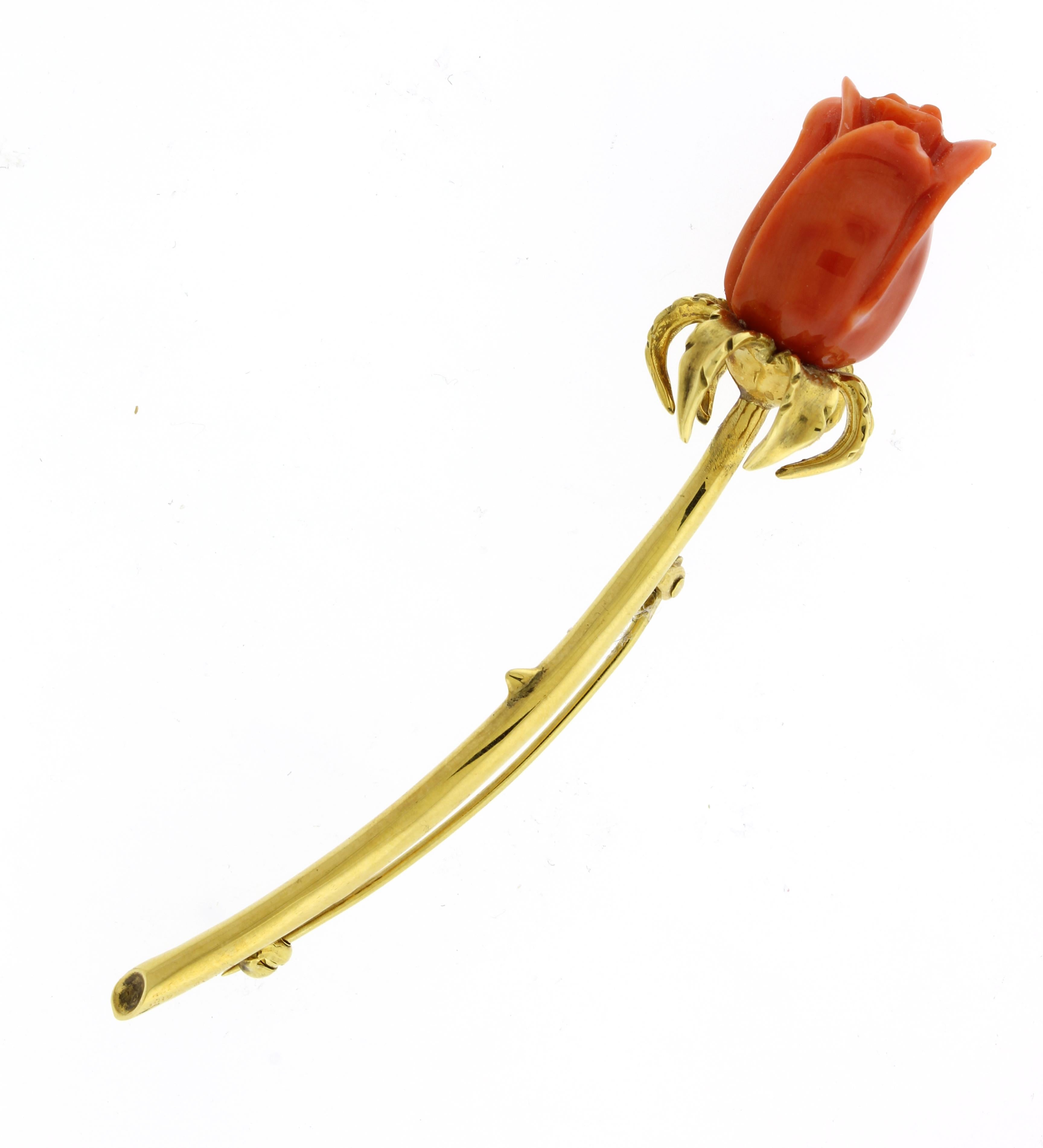 The coral was hand carved into a rose to make this elegant flower brooch.  
• Metal: 18kt Yellow Gold
• Designer: Pampillonia Jewelers
• Gemstone: Coral
• Weight: 12.1 grams
• Length: 3 inches
• Packaging: Pampillonia Presentation Box
• Condition:
