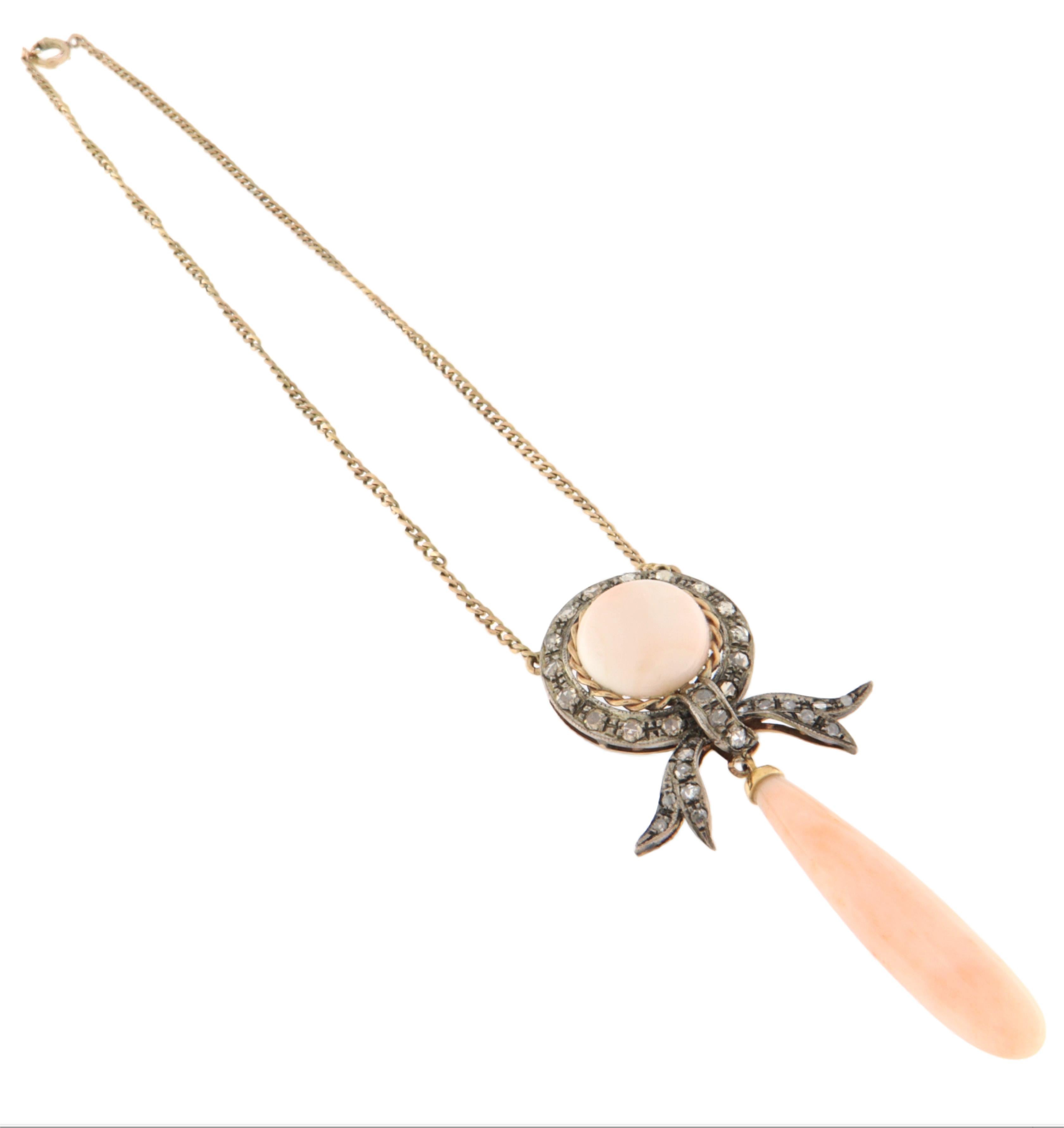 Elegant collier vintage réalisé en or jaune 14 carats et en argent 800, orné d'un fin corail rose et de diamants taillés en rose. Cette pièce raffinée combine magnifiquement des matériaux précieux et un style classique, idéal pour celles qui