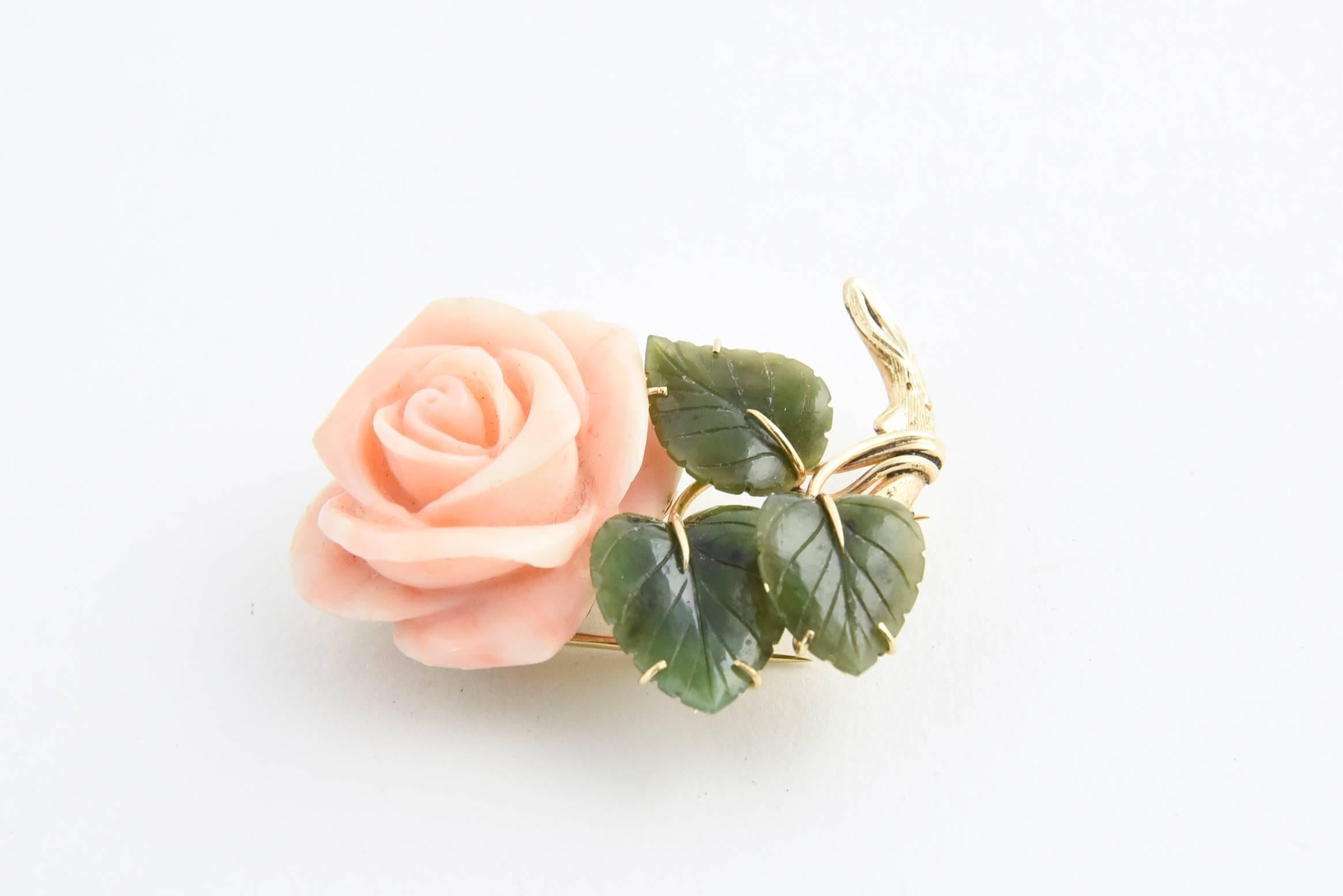 Carved angel skin coral rose with three carved jade leaves mounted in 14K yellow gold. Marked 