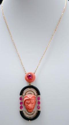 Coral, Rubies, Onyx, Diamonds, 18 Karat Yellow Gold Pendant Necklace.