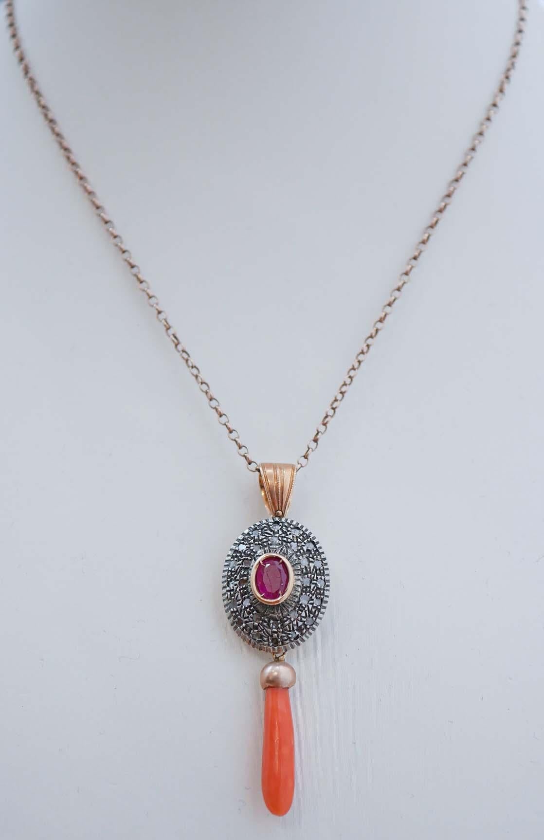 Collana con ciondolo Retrò in oro rosa 14 kt e struttura in argento montata con un rubino centrale circondato da una cornice di diamanti e, come ciondolo, un corallo. Il ciondolo viene fornito con una catena di gomma con chiusura in acciaio.
Questo