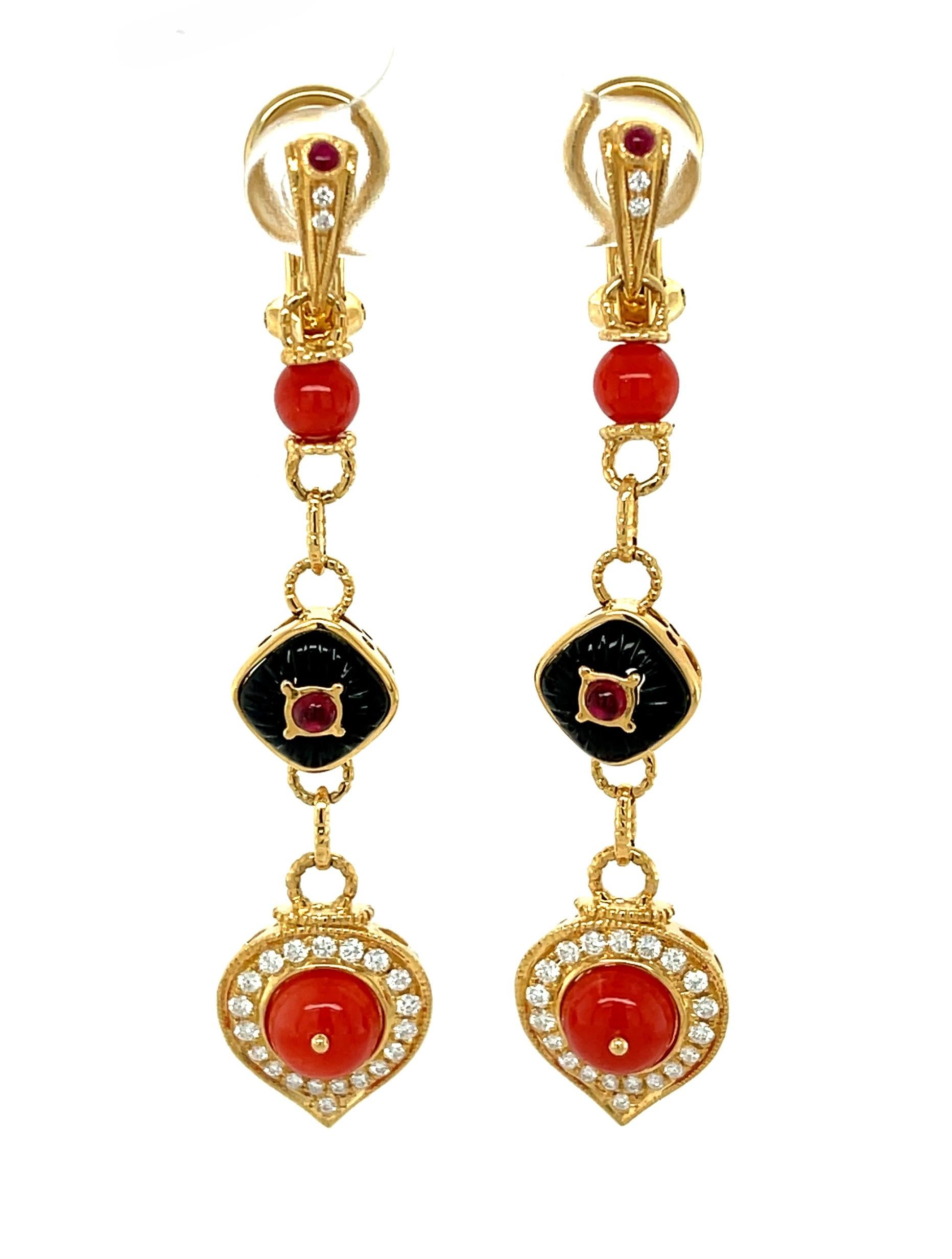 These unusual coral and onyx earrings are a strikingly beautiful combination of red and black.  18k yellow gold spears set with petite ruby cabochons and diamonds sit comfortably on the earlobe, secured by French clip omega backs. Dangling below is
