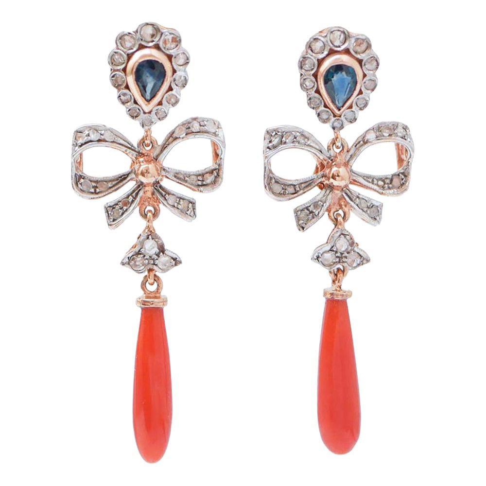 Orecchini in corallo, zaffiri, diamanti, oro rosa e argento.