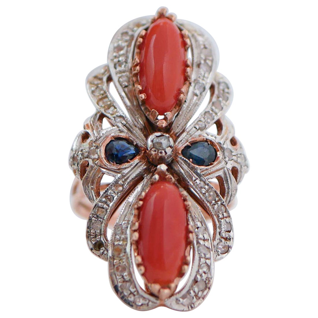 Anello in corallo, zaffiri, diamanti, oro rosa e argento.