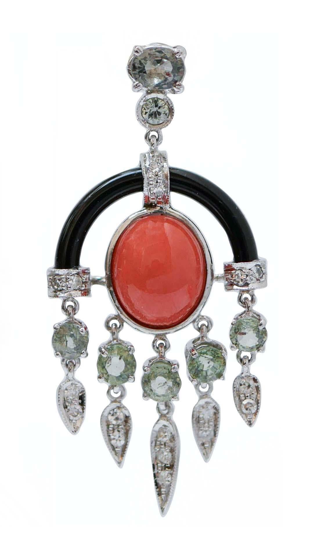 Amazing dangle earrings in platinum structure and 14 kt white gold structure mounted with a two sapphires in the upper part; in the middle, a coral with onyx and, as pendats, structures mounted wit a sapphire and  drops studded with diamonds.
These