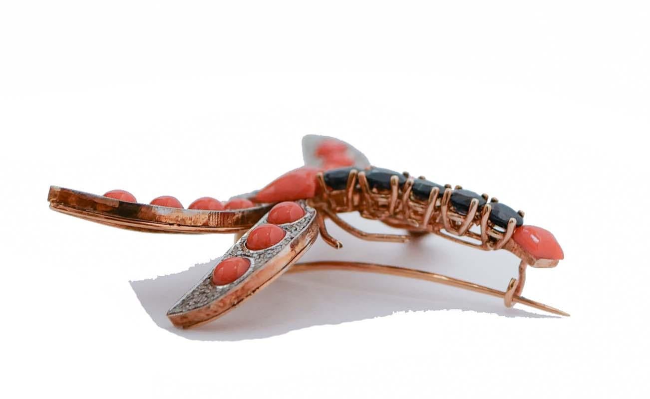 Amazing dragonfly brooch in 9 kt rose gold and silver structure mounted with coral and sapphires on the body; all the wings are studded with diamonds and coral and two rubies as eyes.
This brooch was totally handmade by Italian master goldsmiths and