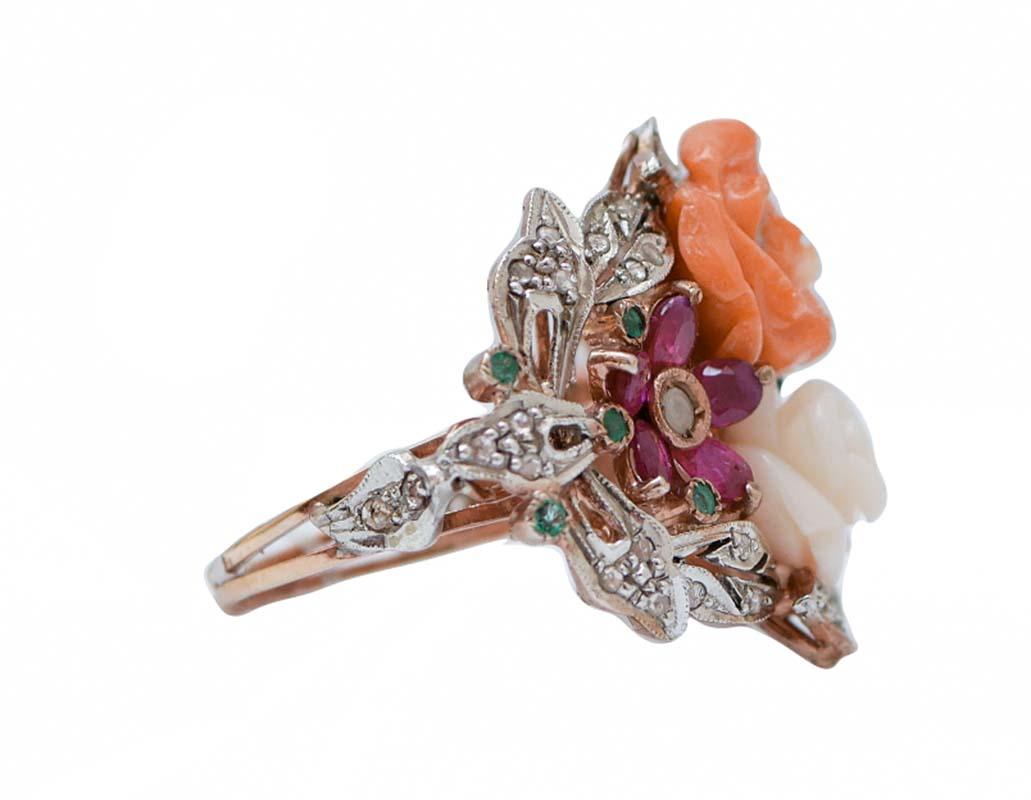Retrò ring in 9 kt rose gold and silver structure mounted with two flowers of coral in the central part surrounded by a flower of rubies and a flower of sapphires laterally. All around, diamonds and emeralds.
This ring was totally handmade by