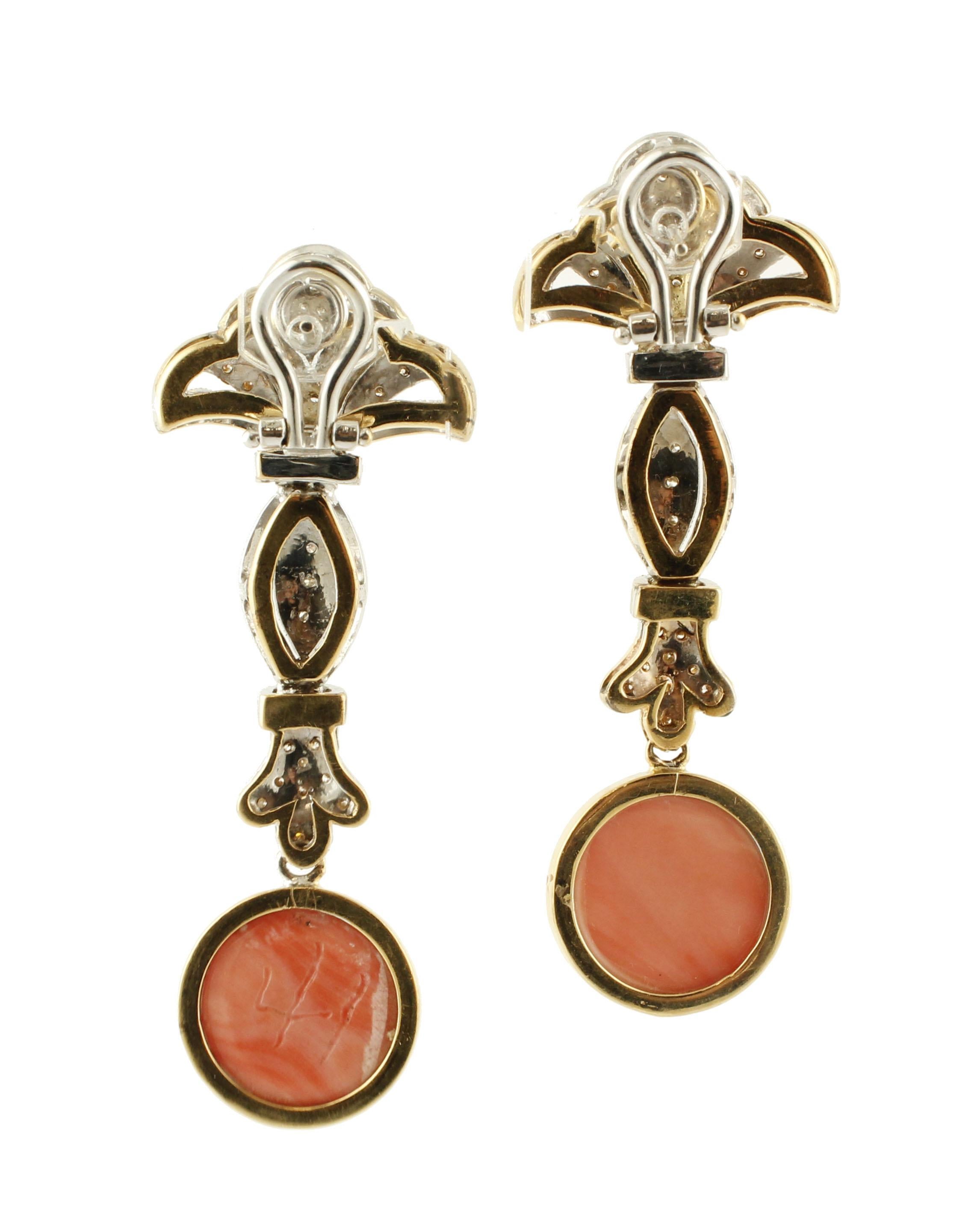 Elegant retro dangling earring,  realized in 18k white and yellow gold structure, studded with 1.84 ct diamonds, and enriched at the bottom by two coral secundum pendents. 
These earrings are totally handmade by Italian master goldsmiths
Diamond