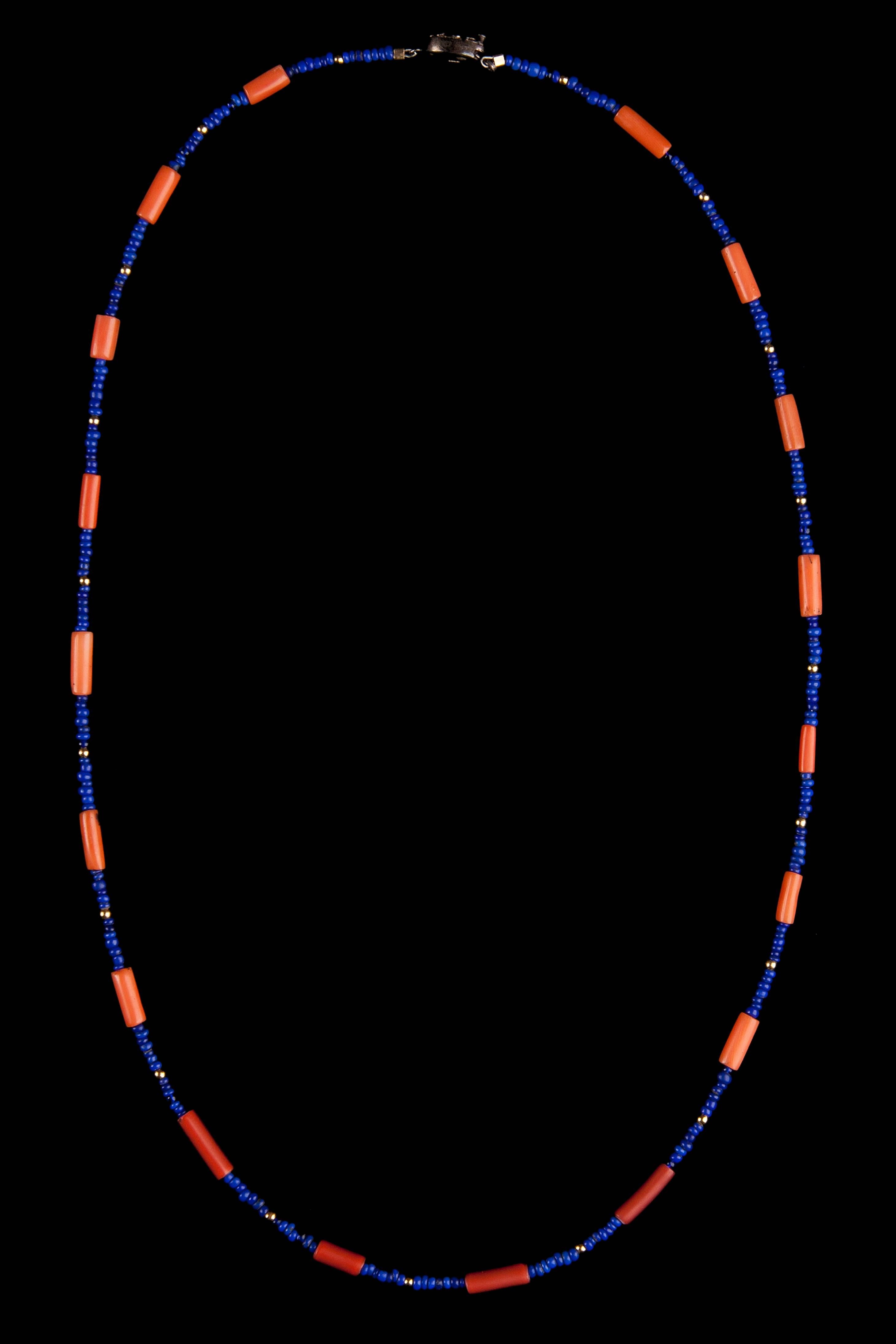 2,500 years of craftsmanship and beauty are arranged in these ancient coral shell and lapis lazuli beads. They are carefully assembled in a very symmetrical form, separated by golden beads. Finished with a beautiful contemporary clasp.