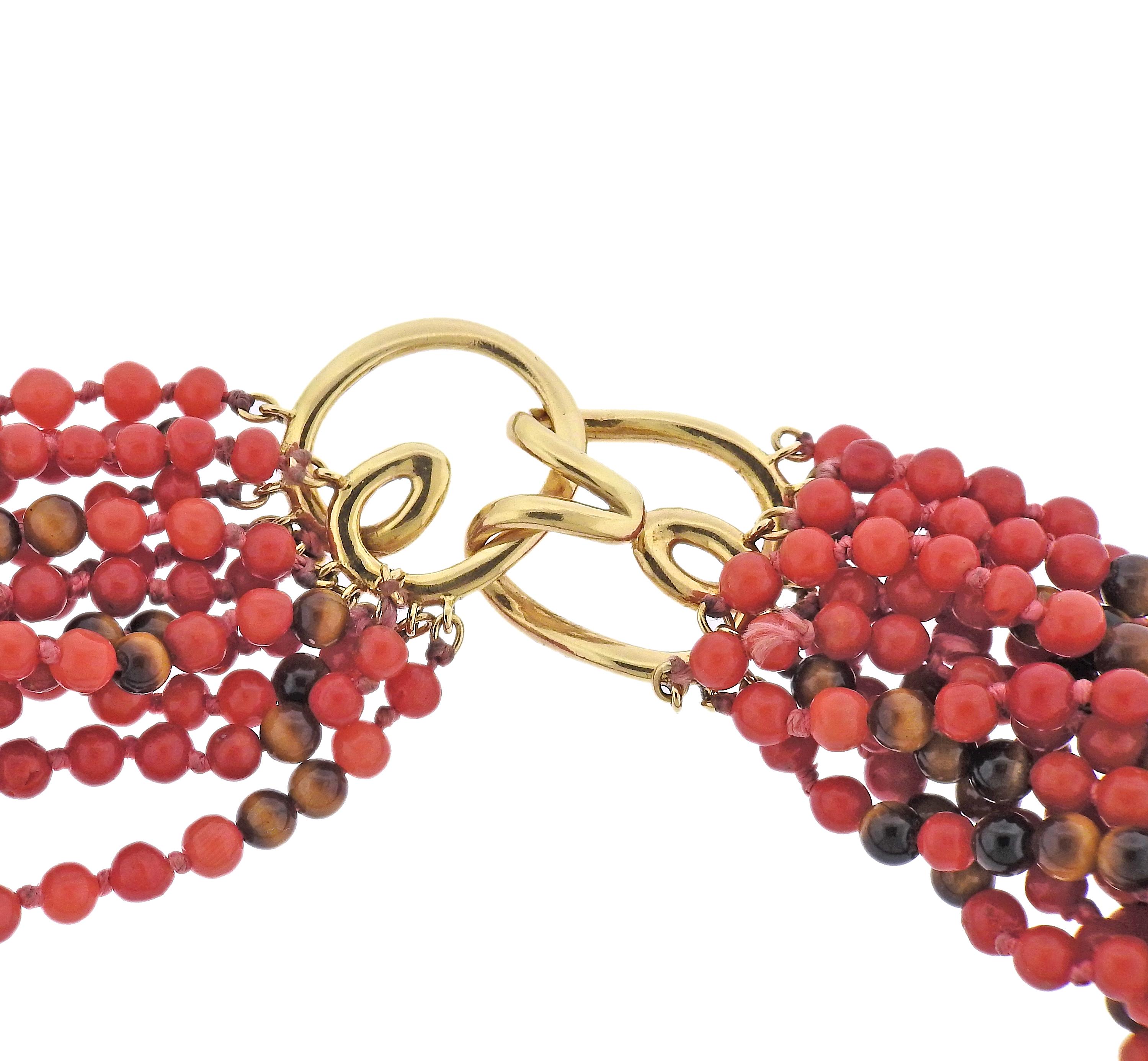 18k gold torsade necklace, with 12 strands of tiger's eye and coral beads. Necklace is approx. 18.5