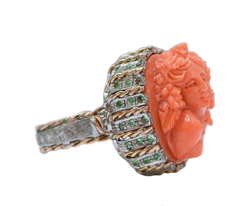 Amazing ring in 14 kt rose gold and silver structure mounted with a carved coral representing a lady motif set in a structure studded with diamonds and tsavorite.
This ring was totally handmade by Italian master goldsmiths and it is in perfect