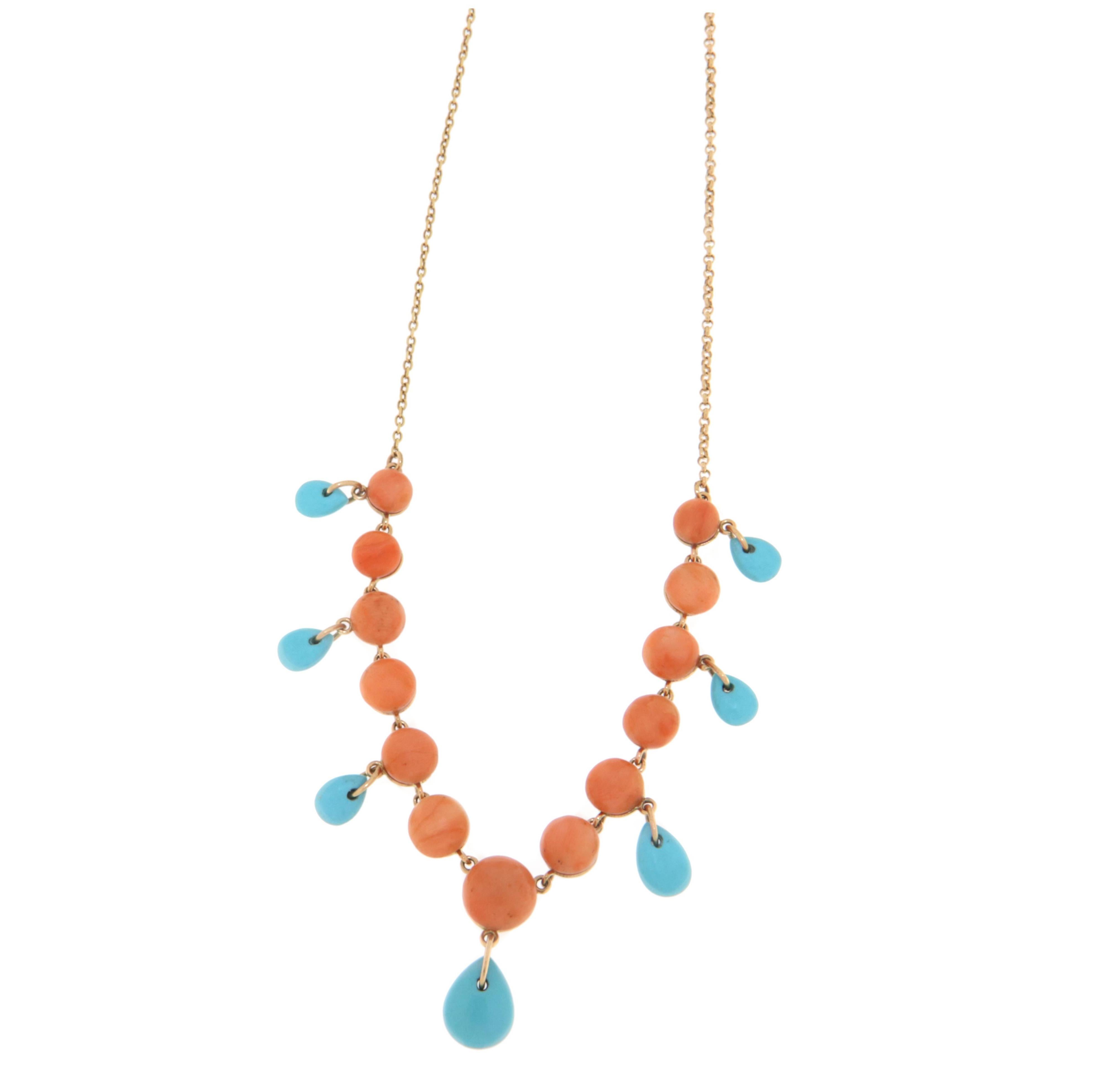 Elegant and sophisticated, this 14-karat yellow gold necklace combines the natural beauty of turquoise and coral to create a timeless piece of jewelry. The necklace features a delicate chain crafted in 14k yellow gold, chosen for its durability and
