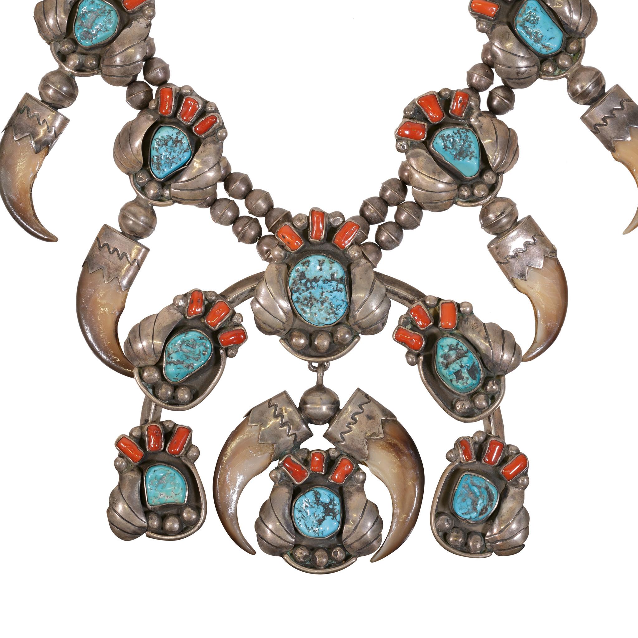 The turquoise is from the Kingman Mine in Arizona. Bear claw with turquoise and coral. Twelve claws total. Exceptional; museum quality.

PERIOD: Est before 1950

ORIGIN: Navajo, Southwest

SIZE: Length 31 1/4