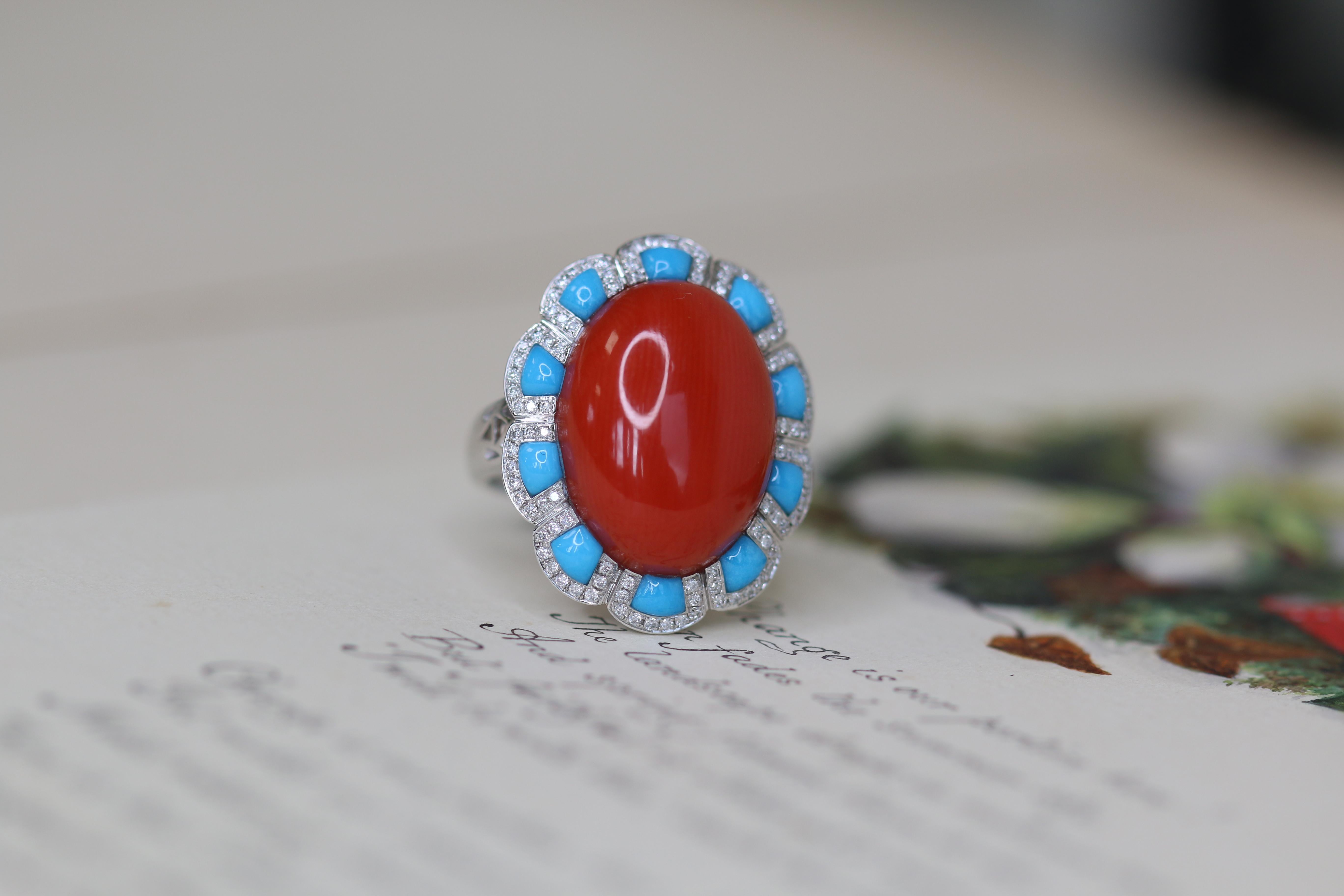 This beautiful coral ring has the classic combination of red, white and blue; coral, diamond and turquoise. These are arranged into a strikingly beautiful cocktail style ring. The flawless, natural deep red coral sits at the centre of the design.