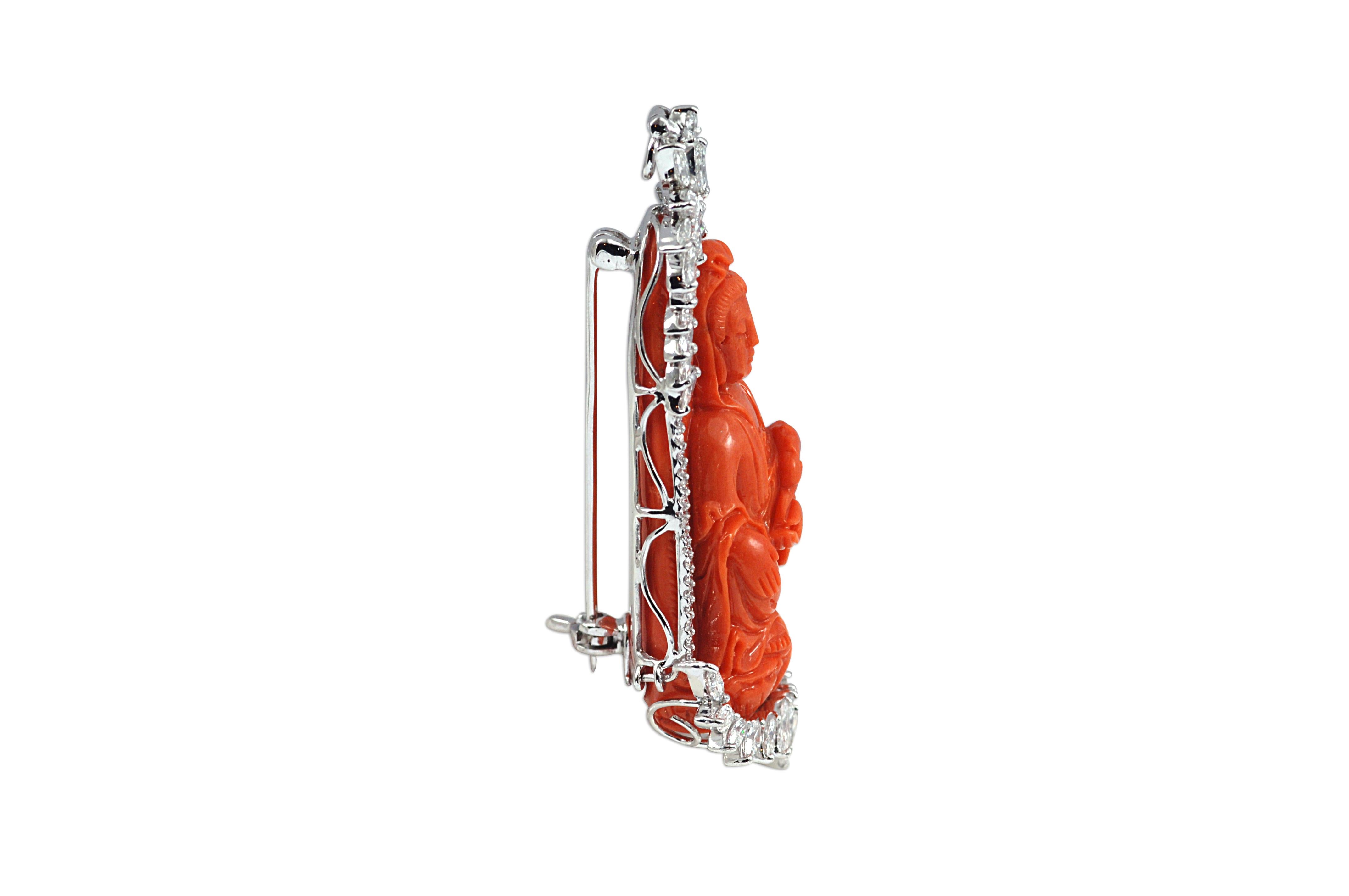 A Coral carving of a buddha:  80.75 carats with Diamond 2.46 carats, Diamond 0.31 carat Brooch Set in 18 Karat White Gold Settings

Width:2.4 cm
Length: 6.0 cm 
Weight: 26.71 grams

