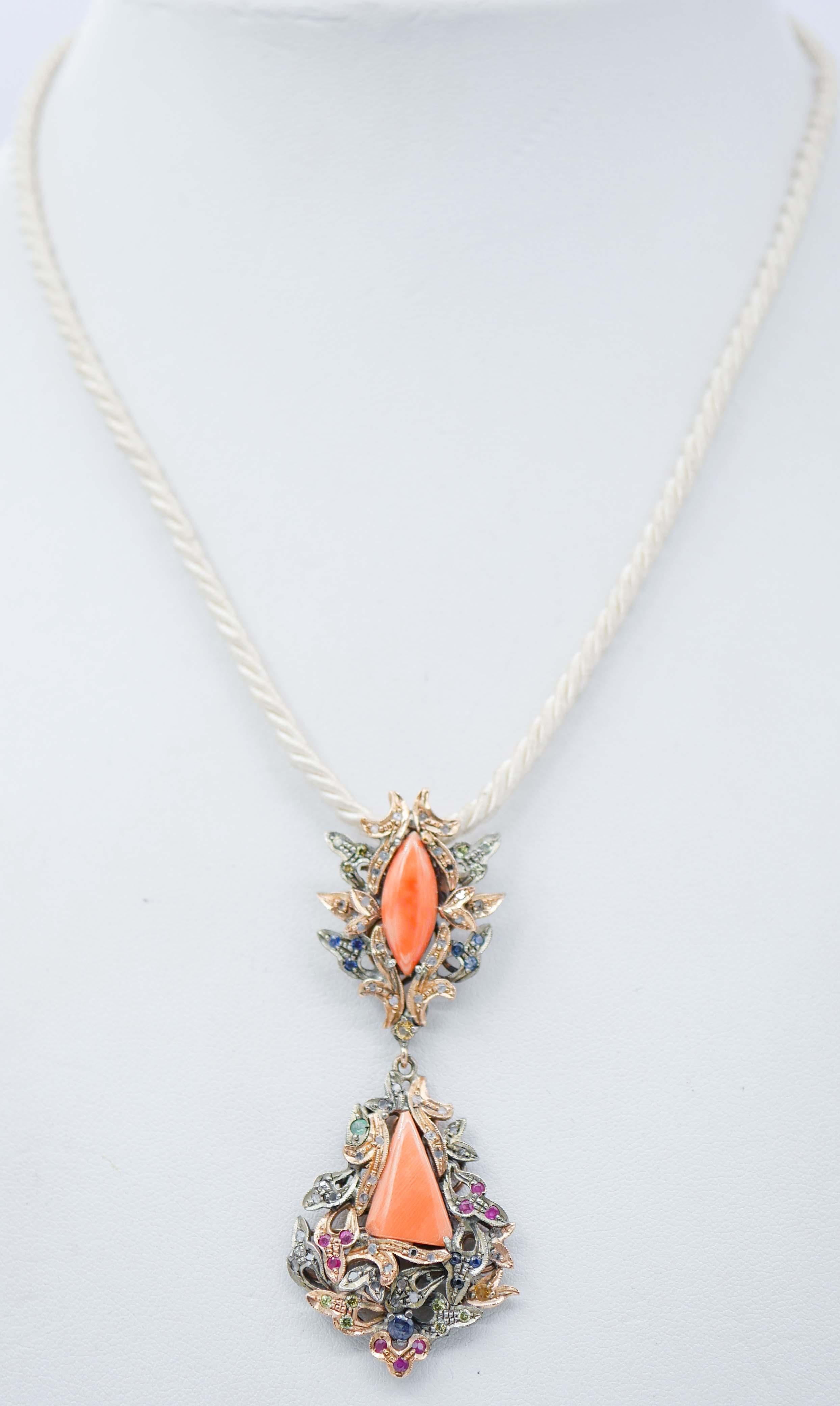 Beautiful retrò pendant in 9 kt rose gold and silver structure mounted with a coral in the upper part surrounded by diamonds and sapphires. Below,another structure mounted with a central coral surrounded by diamonds,emeralds and sapphires.
This