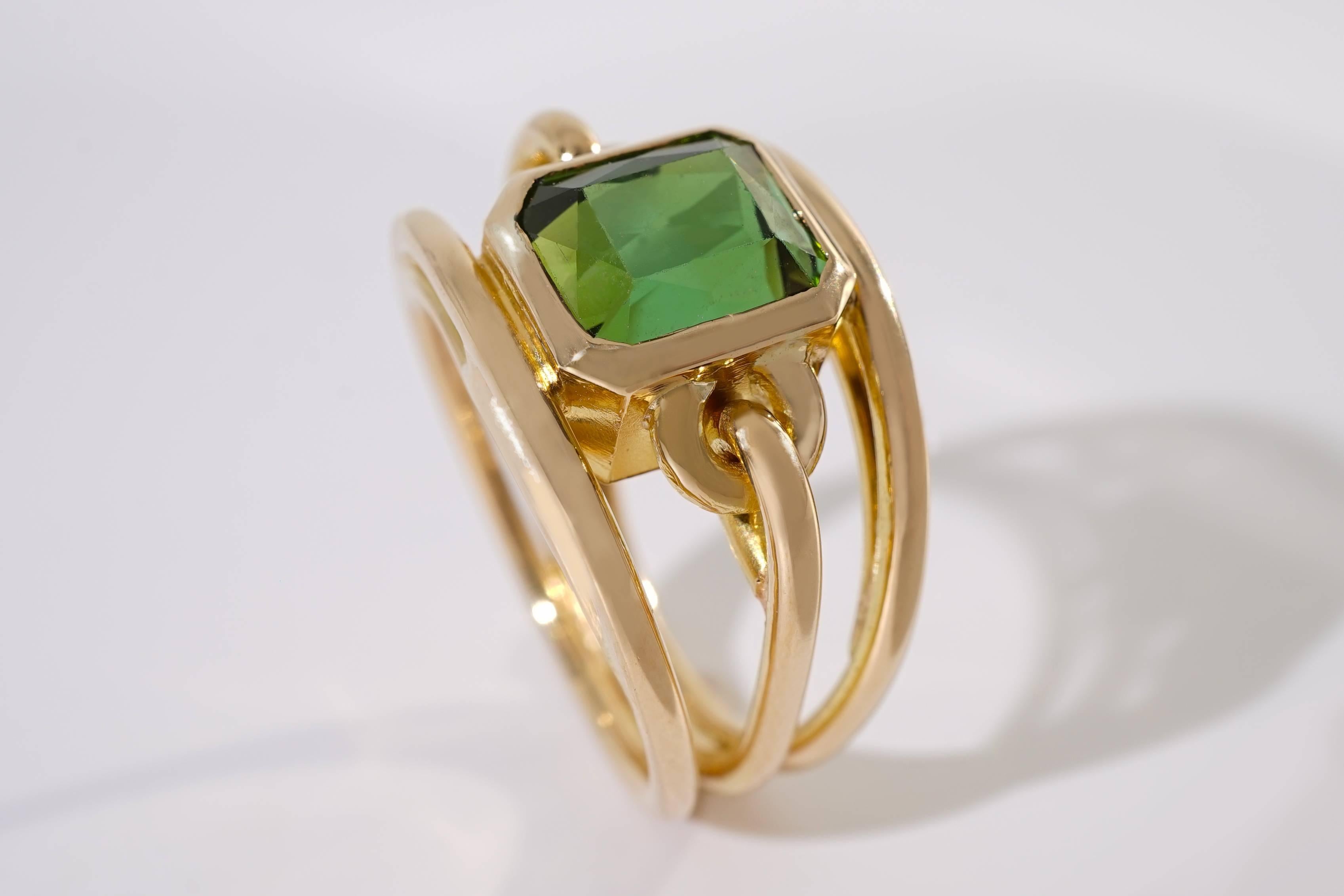 Coralie Van Caloen Gold 18 Carat Strap Band Ring With Green Tourmaline is entirely hand made and forged in Belgium by experts goldsmiths therefore it is a very unique piece. The design of the ring is elegant and contemporary. The Tourmaline has