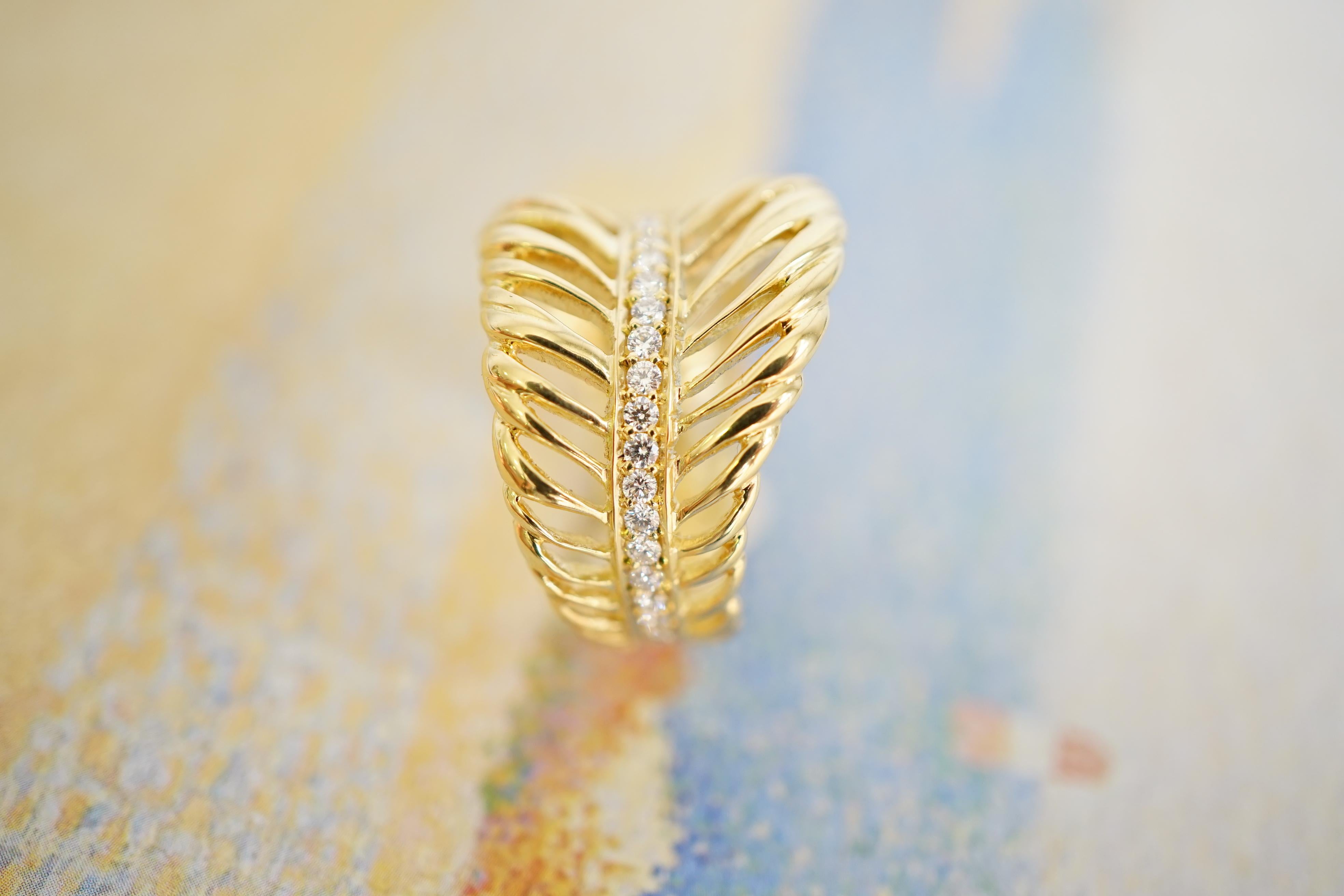 Coralie Van Caloen 18k Gold Feather With Diamonds Band Ring is entirely hand made and forged in Antwerp (Belgium) by experts goldsmiths therefore it is a very unique piece. The ring has gradient sized old European cut diamonds all across the band.