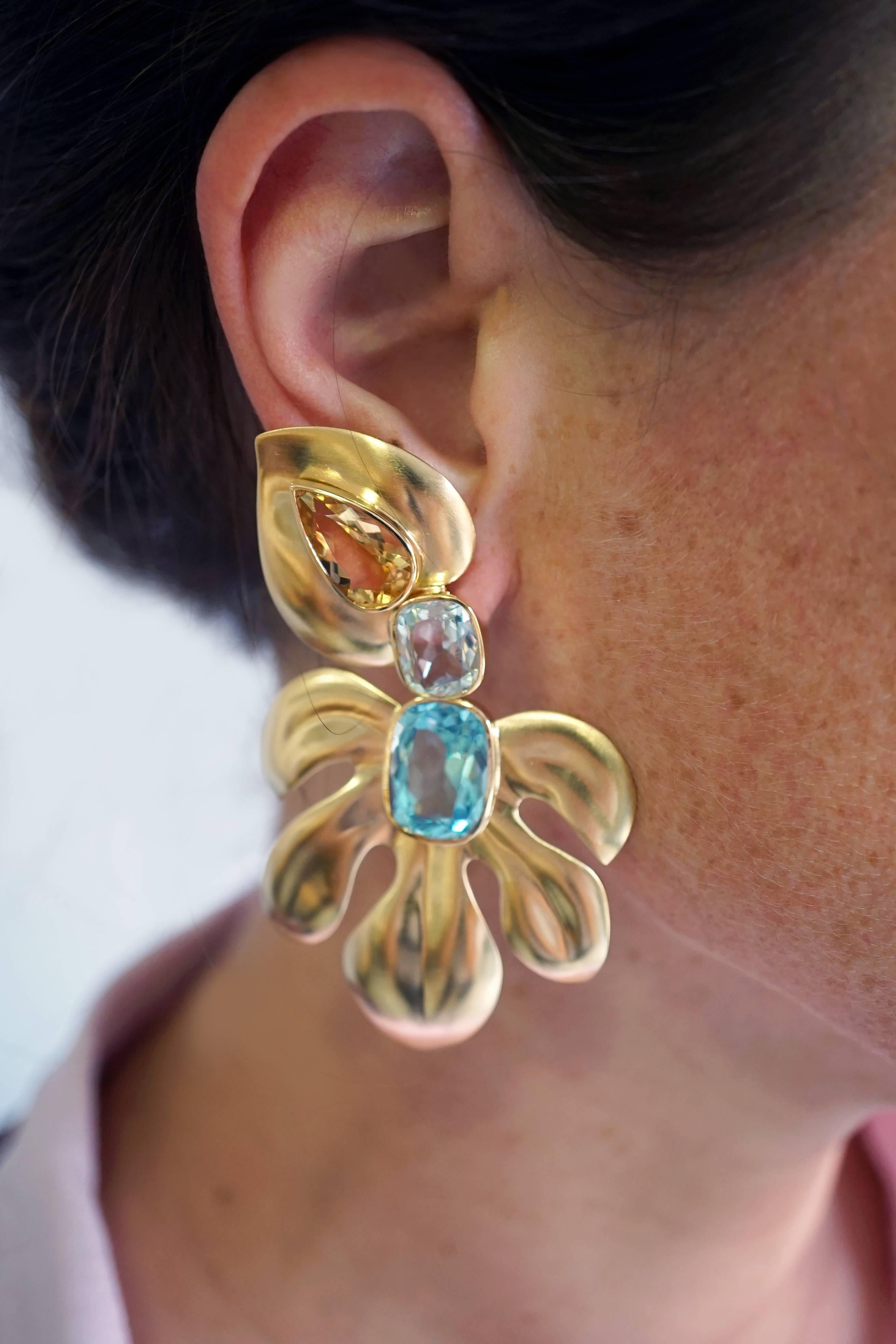 Coralie Van Caloen 18k Gold Beryl And Aquamarine Tropical Clip-on Earrings are entirely hand made and forged in Belgium by experts goldsmiths therefore they are very unique. The earrings are set with beryls and different shades of blue aquamarines