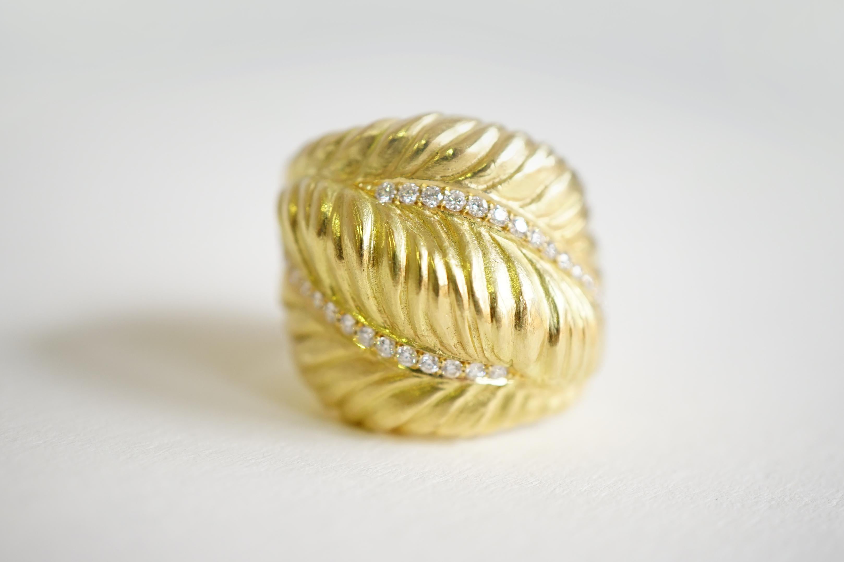 Coralie Van Caloen 18k Gold Crossover Feathers with Diamonds Band Ring is entirely hand made and forged in Antwerp (Belgium) by experts goldsmiths therefore it is a very unique piece. The ring has gradient sized old European cut diamonds all across
