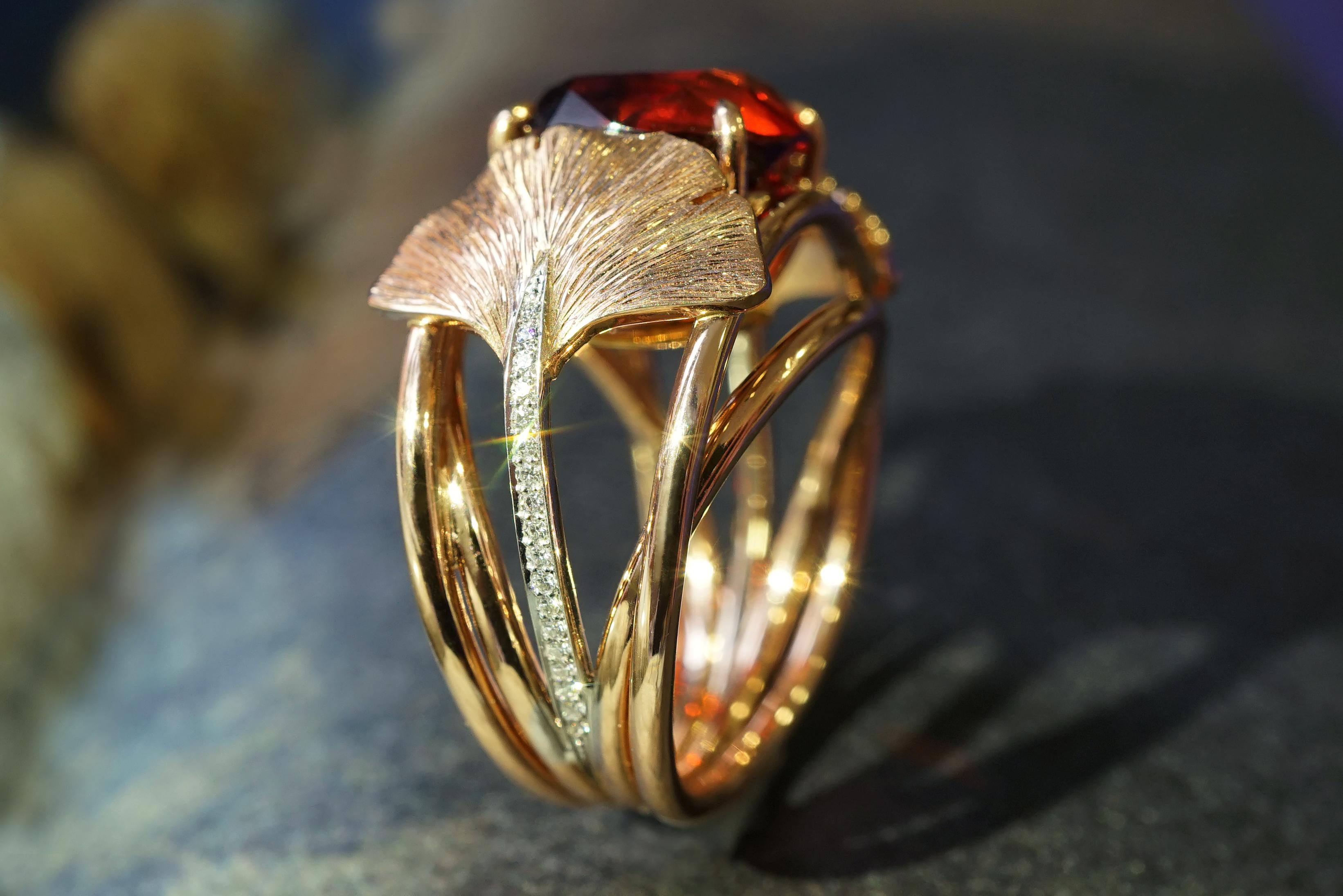 Coralie Van Caloen 18k Red Gold Ring With Red Garnet, Diamond And Engraved Gingko Leaves is entirely hand made and forged in Belgium by experts goldsmiths therefore it is a very unique piece. The bright red garnet has a very vibrant colour and sits