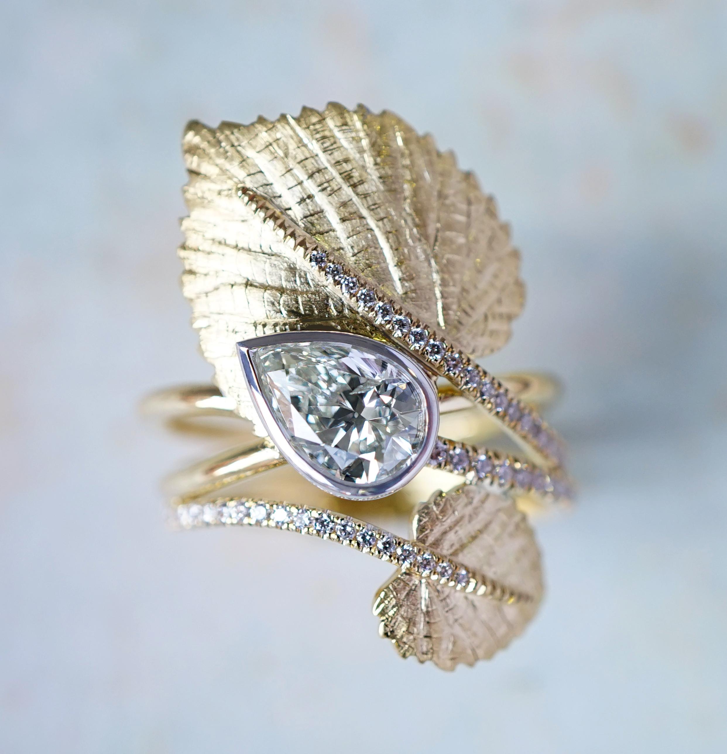 Coralie van Caloens 18k Yellow Gold Botanical Ring And Pear Shaped Diamond is entirely hand made and forged in Belgium by experts goldsmiths therefore it is a very unique piece. The ring is very organic with the hand engraved linden leaves wrapping