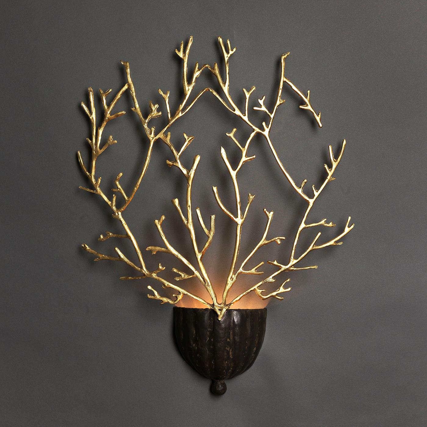 Named after the Italian word for corals, this stunning sconce evokes these marine creatures in the organic texture in the striking branches that form its silhouette. The lightweight body is crafted of brass, reflecting the light coming from the two