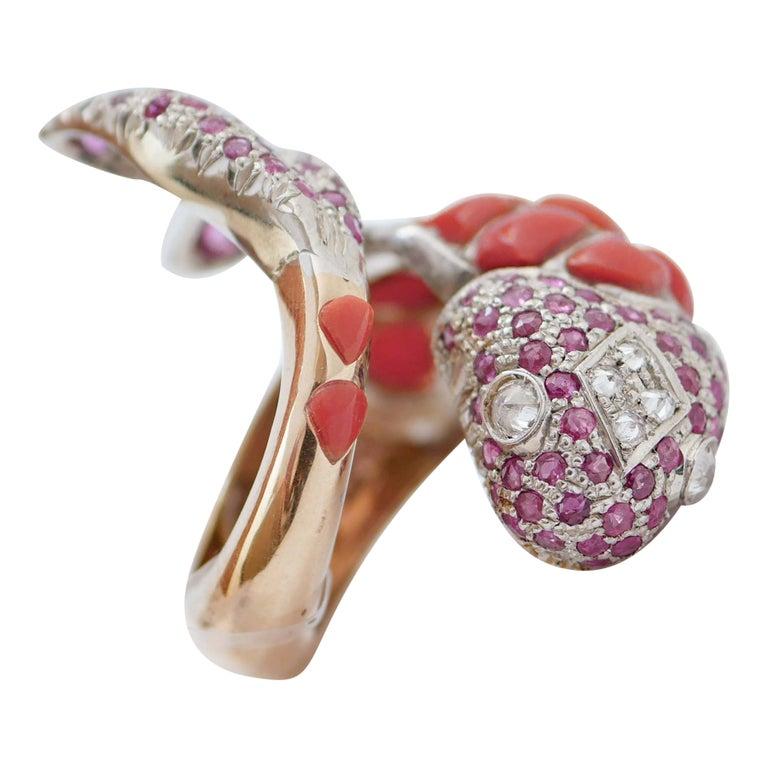 Fashion fish shape ring in 9 kt rose gold and silver structure mounted with coral on the body; tail and head are studded with rubies. In the central part of the head, diamonds and two diamonds as eyes.
This ring was totally handmade by Italian