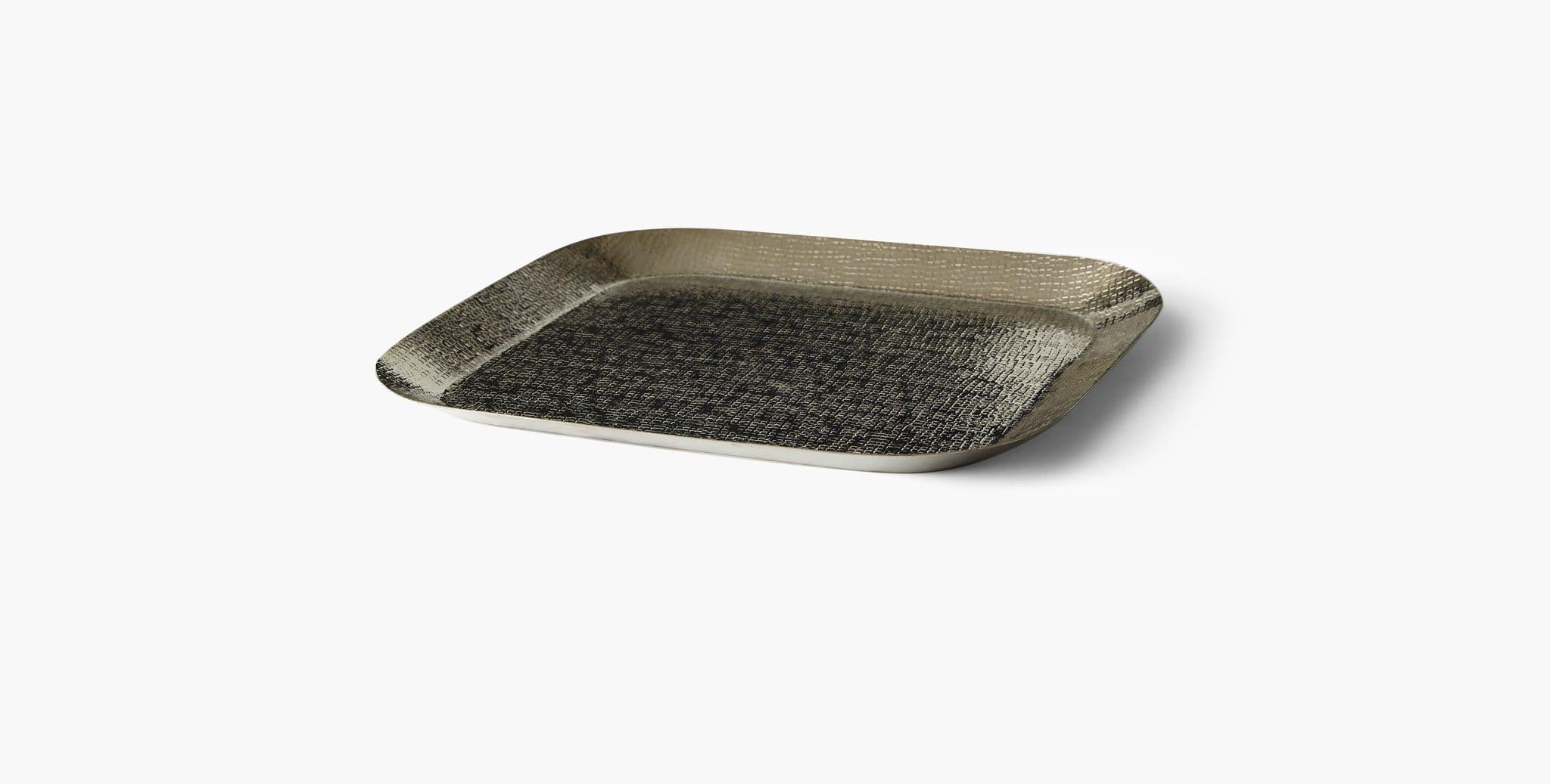 Our Corba Platter provides an elegantly rounded square backdrop for curated objects. Place it on a side or entry table for a bold textural accent. Our handcrafted finishes are inspired by variations within natural textures. Each selection is