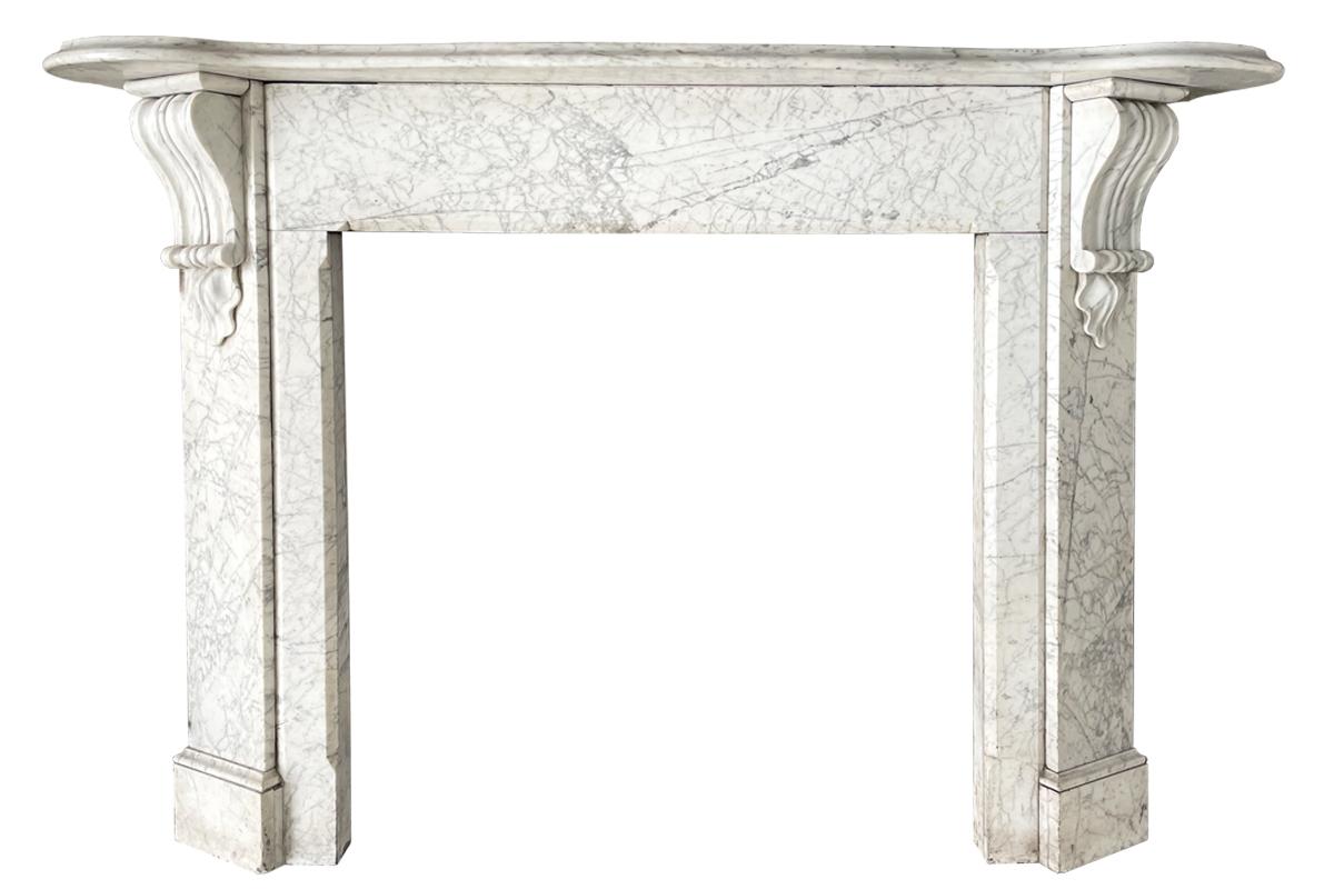 Victorian strikingly figured Carrara marble fireplace surround with canted jambs terminating in well carved corbels and petals flanking a long plain frieze with a simple stop chamfer framing the aperture, circa 1870.

Images prior to restoration,