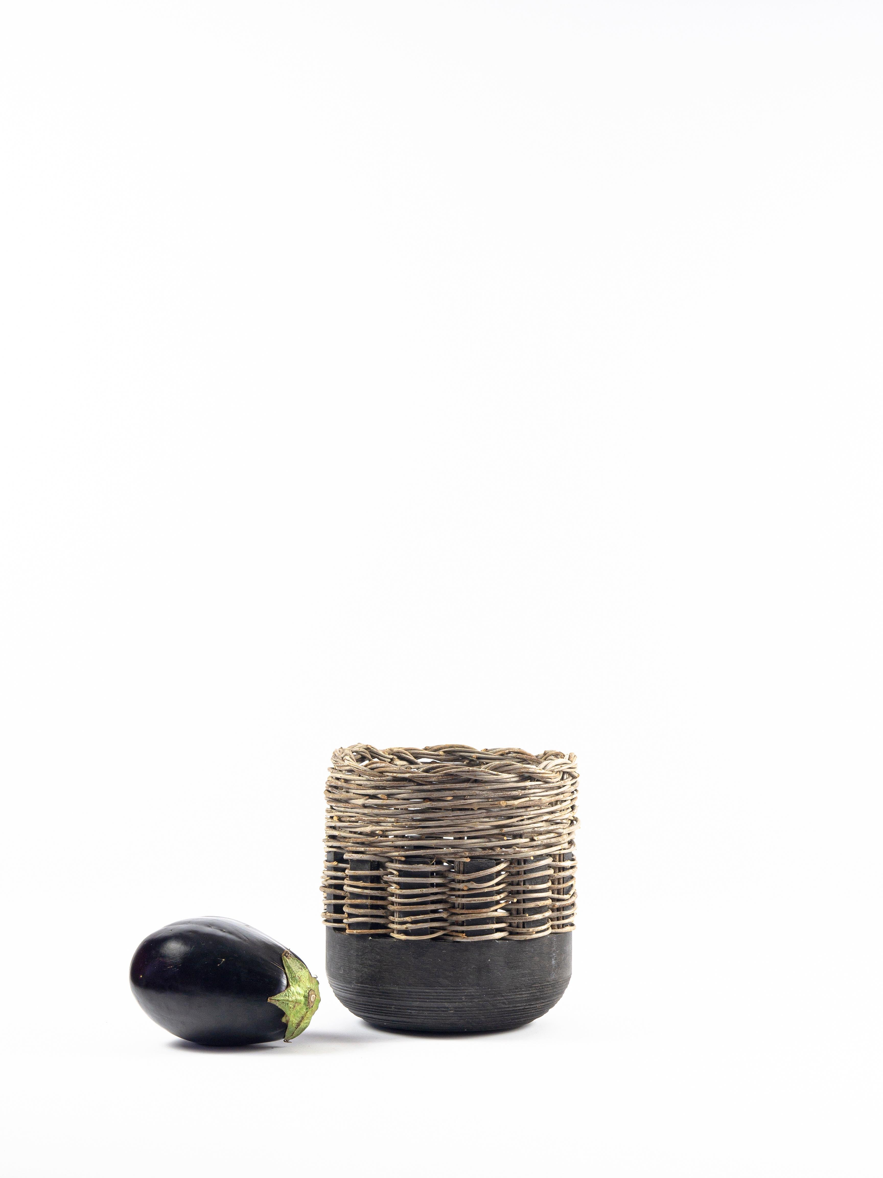 A collection of vases in Jerissa Stone and intertwined olive branches that comes from the theme of the 