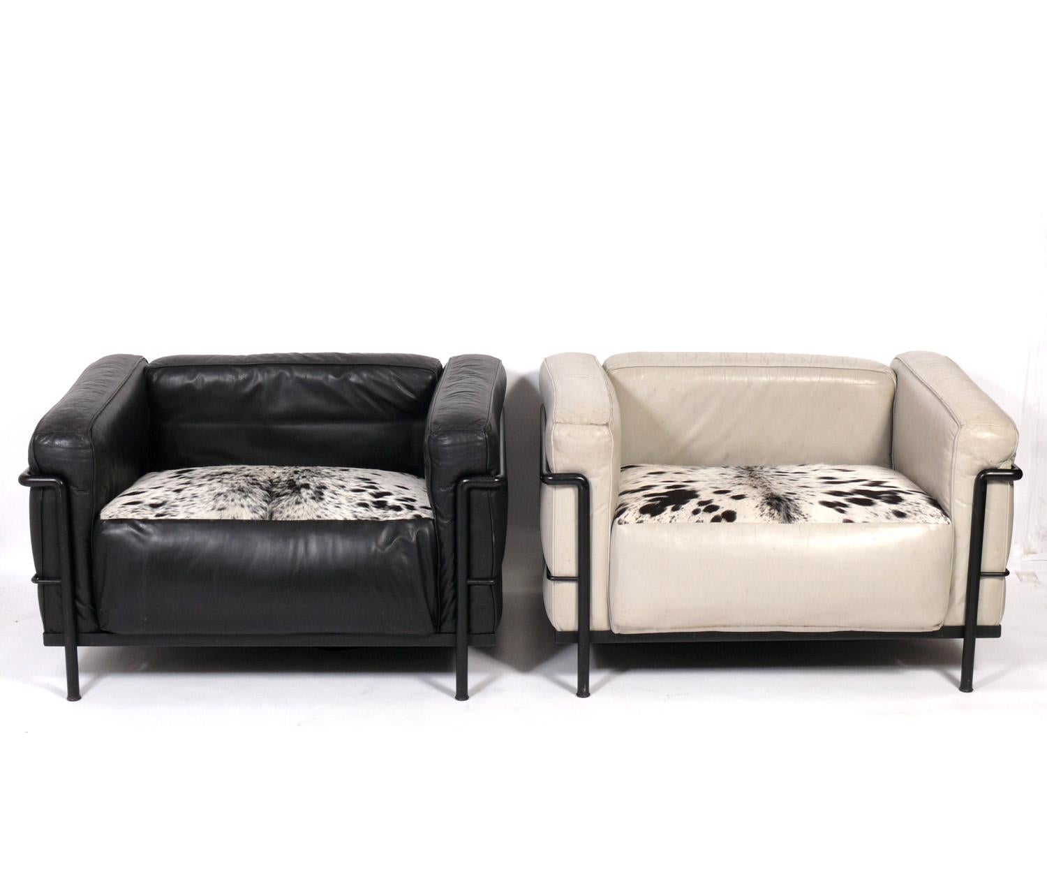 Pair of Leather and Cowhide LC-3 Lounge chairs, designed by Charlotte Perriand, Pierre Jeanneret, and Le Corbusier, originally designed in 1928, these chairs are authorized re-editions for Cassina, circa 1990s. These retain their original leather,