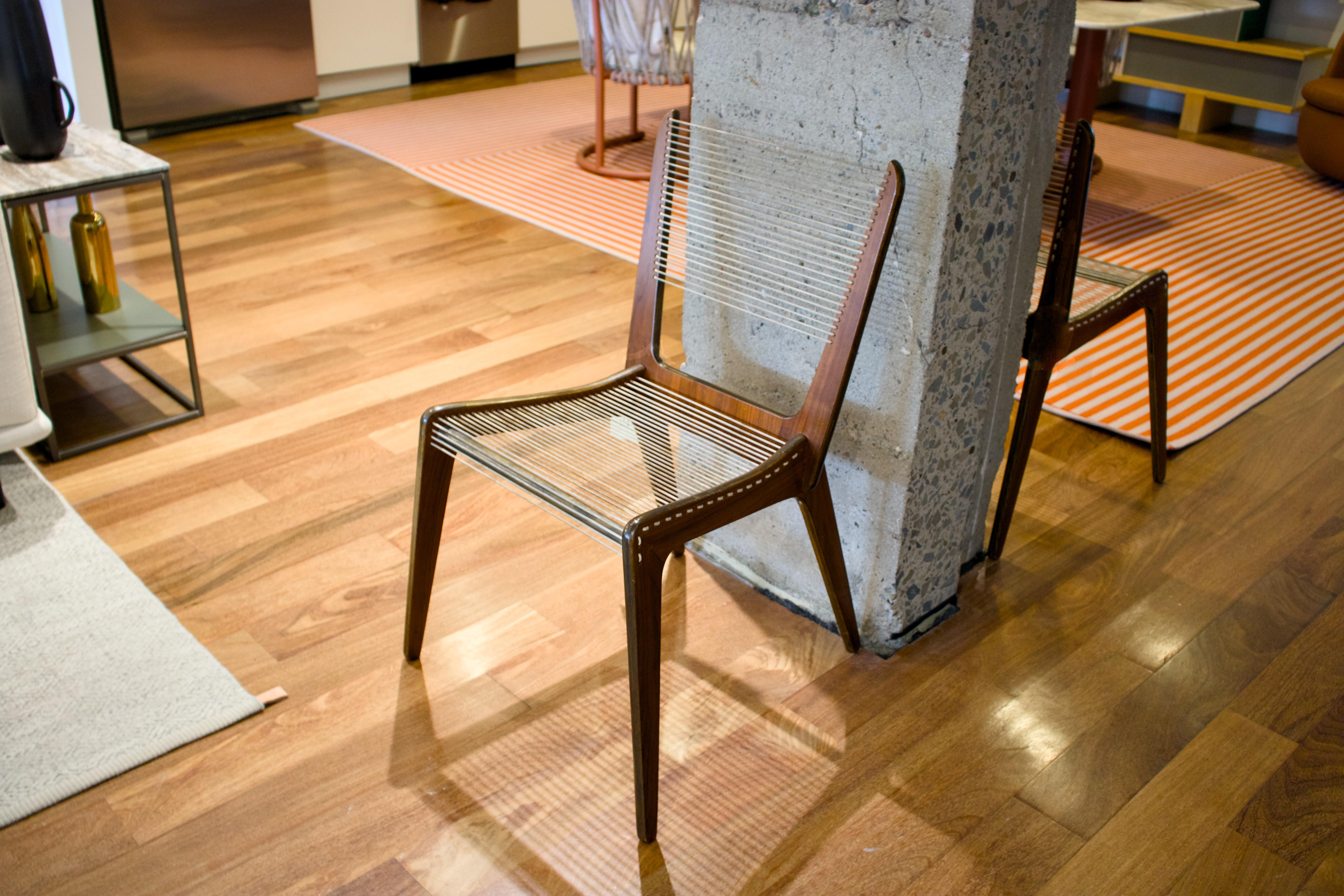 Designed in 1953 by Jacques Guillon, the Cord Chair is a hallmark of mid-century modern design. Its form is defined by three U-shaped maple wood elements and a seat and backrest made from tightly strung nylon cords, emphasizing both lightness and