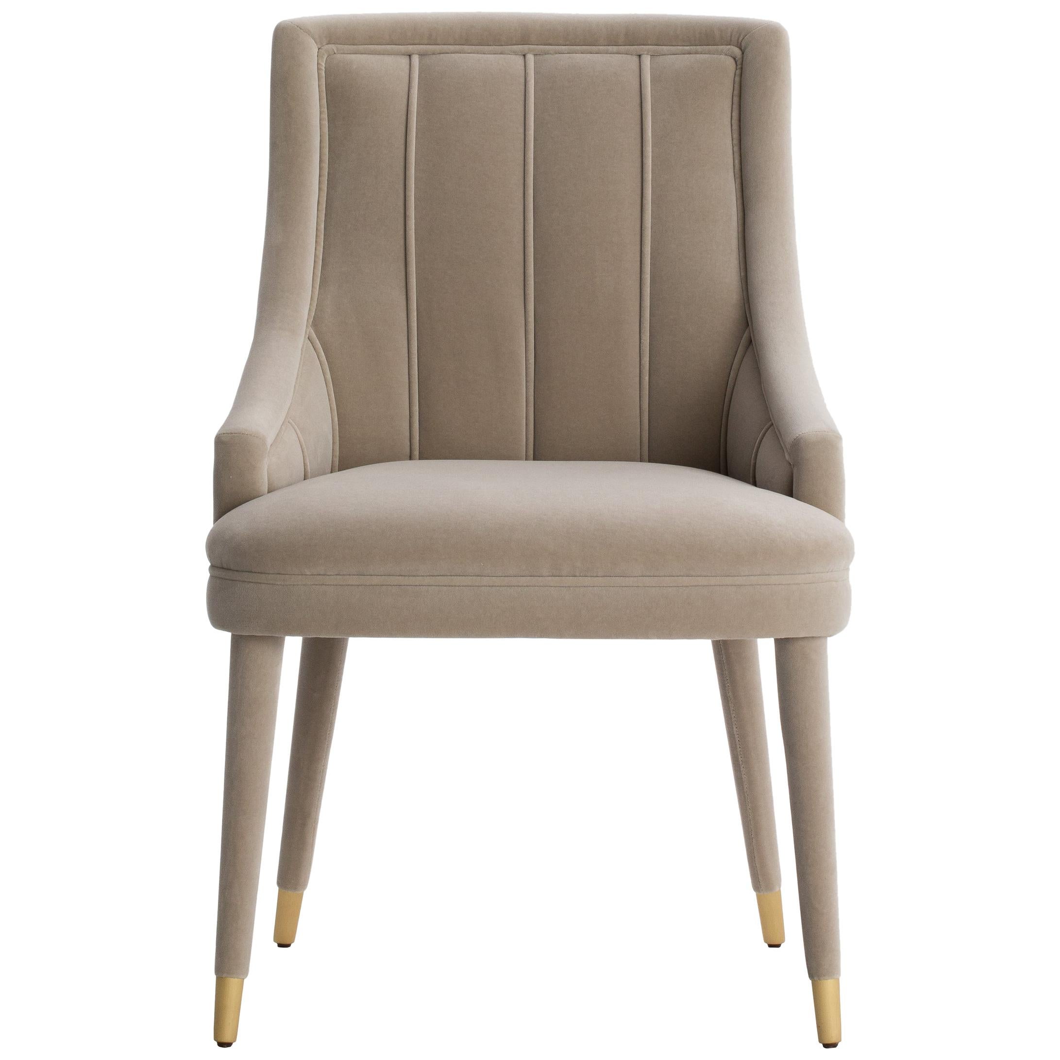 Elegant and timeless design, the CORDOBA  chair is very comfortable and engaging.‎ The upholstery runs through the legs, finishing with beautiful metal tips in brass but also available in steel.‎ 
Cordoba is available to order in fabric,