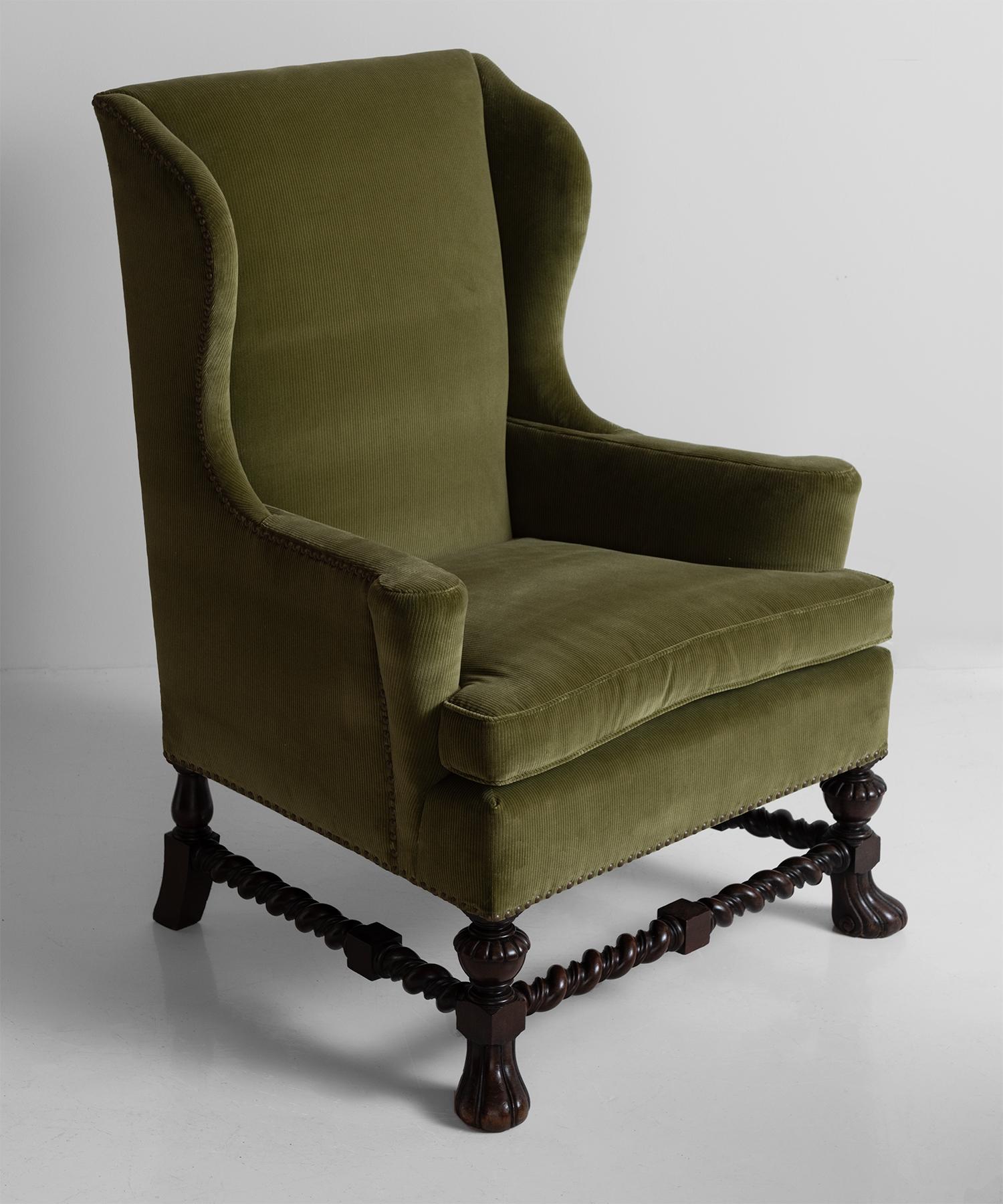 Corduroy wing chair, England, circa 1840.

New upholstery with brass stud work on rosewood jacobean style legs.