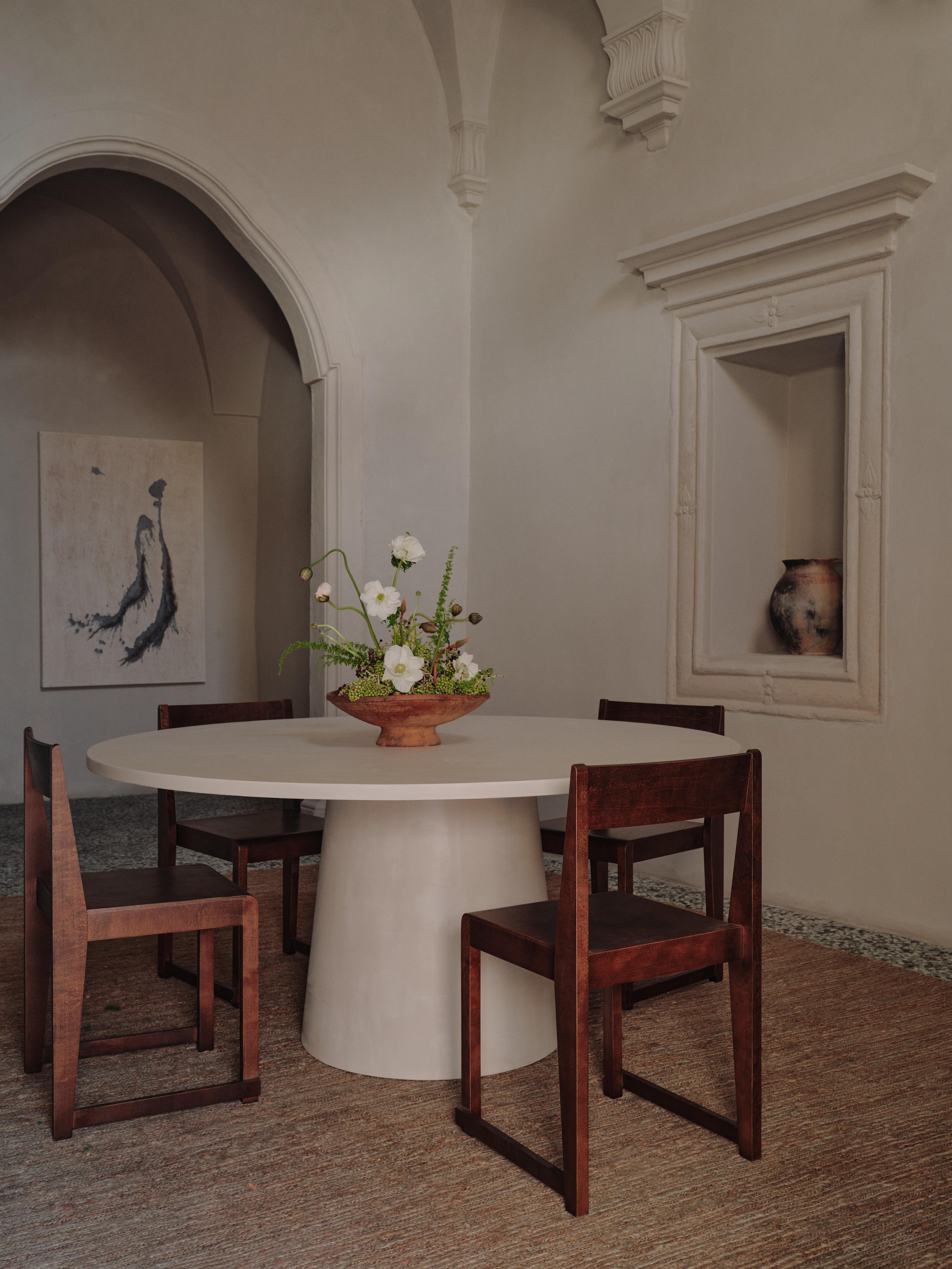 Handcrafted in Spain by expert artisans, this oval-shaped dining table from Marlot Baus combines timeless design with modern craftsmanship. Each piece is carefully made using our signature microcement technique, layered by hand to achieve a smooth,