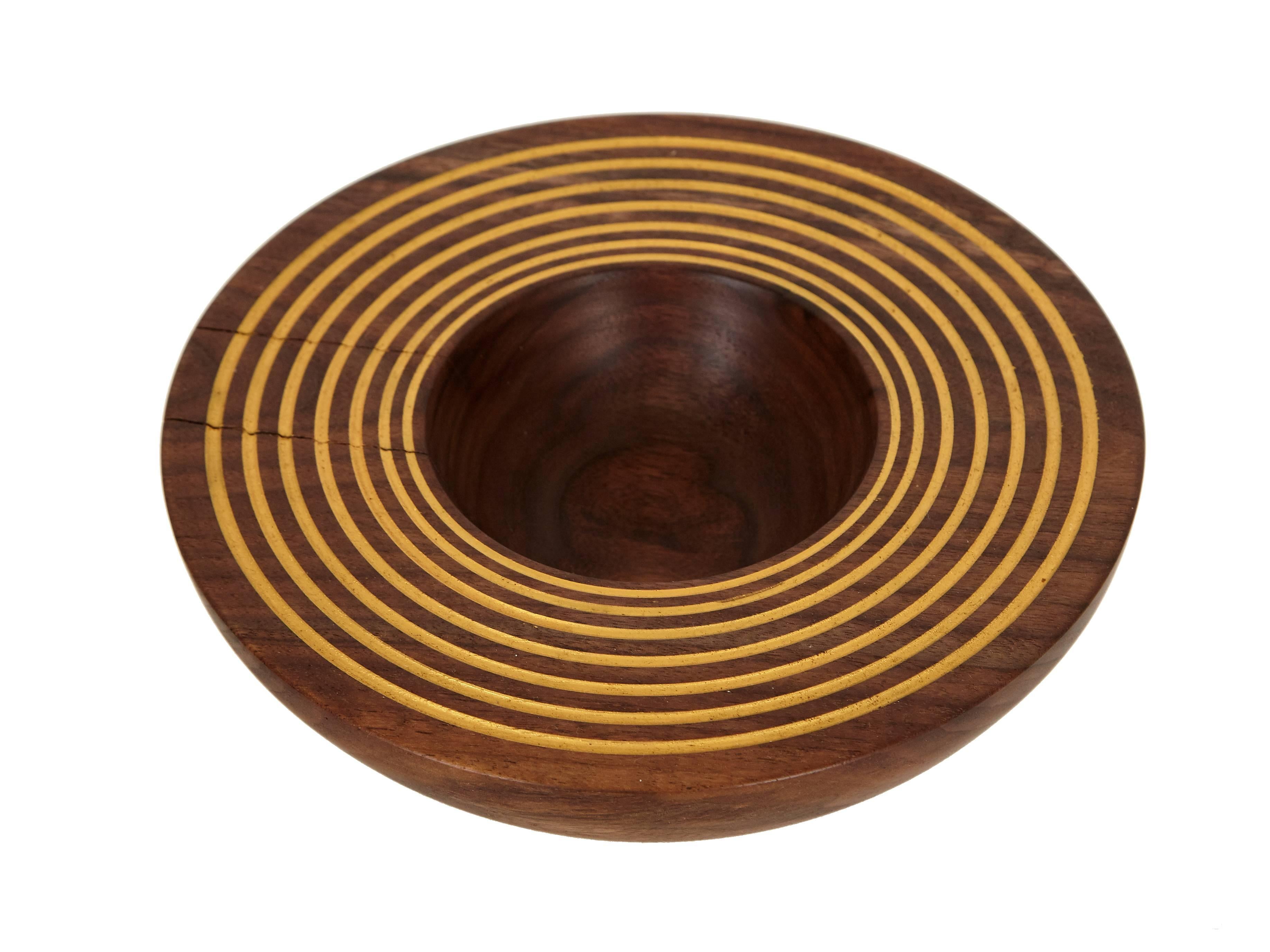 Core Series black walnut bowl by Claudio Sebastian Stalling lathe turned and finished by hand with gold paint detailing.

Originally from the German Alps, and trained in the traditional woodworking mastery of the German lineages, Claudio Sebastian