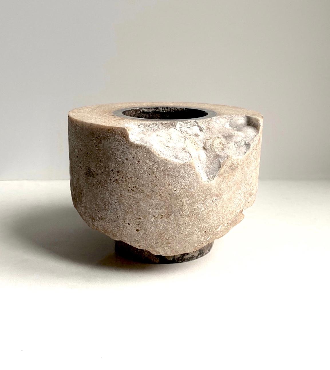 Cored Vessel by Cal Summers
Dimension:  D 15.24 x H 11.43 cm
Materials: Resin and Sawdust Composite with Steel Inset.

Cal Summers is a British designer who makes bespoke handmade furniture and contemporary artefacts in which he challenges the