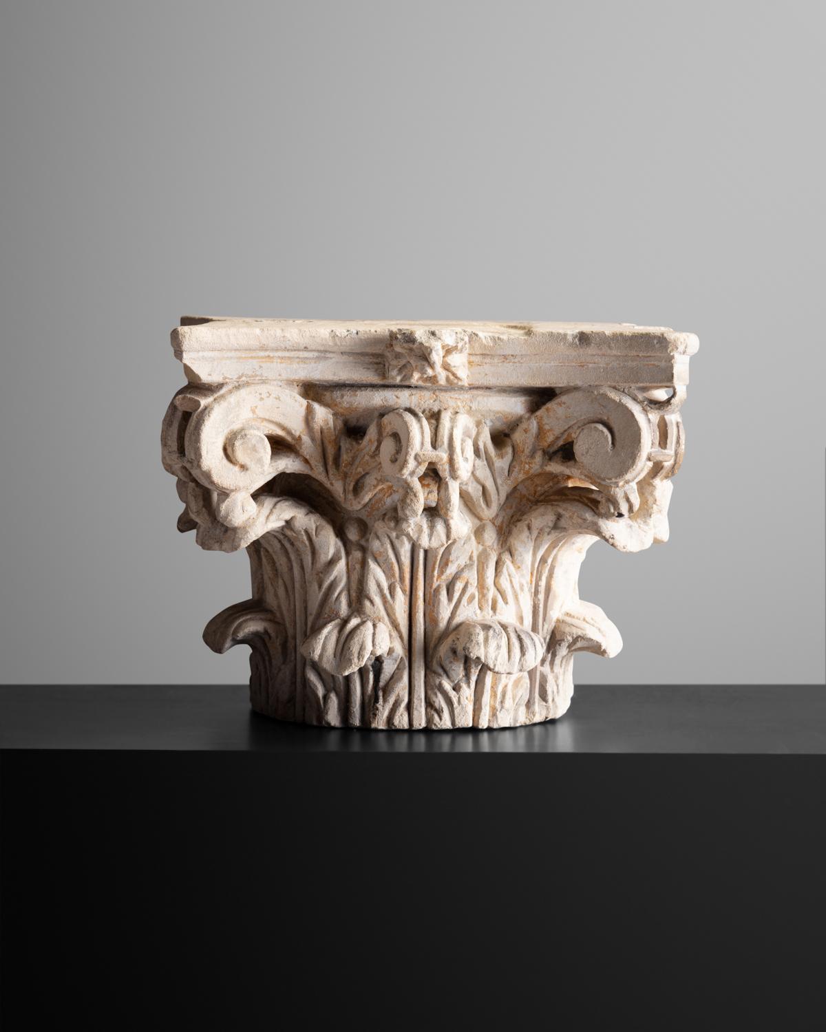 Limestone, carved on four sides with acanthus and scrolls, with traces of primer.