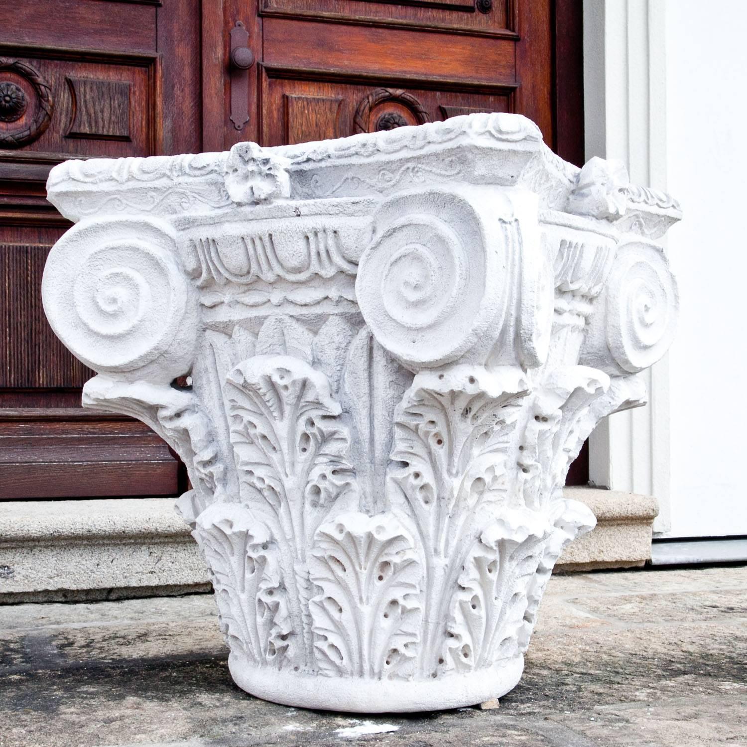 Hand-carved Corinthian capital with a square shaped base, hand-carved out of natural stone.