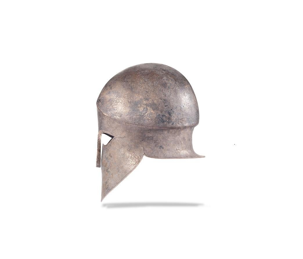 Named after the Ancient Greek city-state of Corinth from where the style originated, this Corinthian helmet would have been worn by a hoplite soldier, both in and out of combat. Its distinctive shape, with a bell-like crown, almond eyes, teardrop