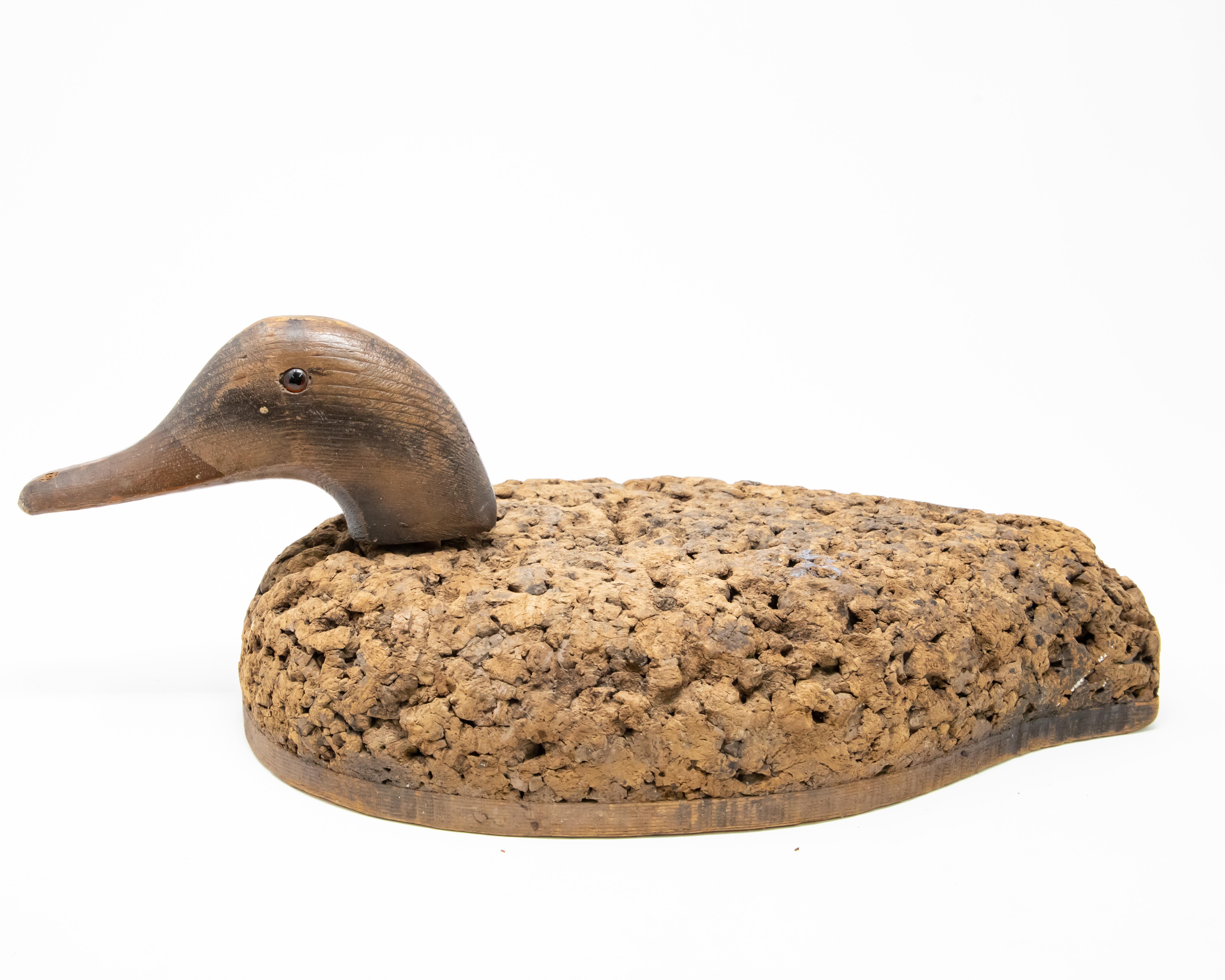Offering this neat little Duck Decoy with a cork body and removable wooden head. Interesting texture to the body from age of the cork. Also think he would make a neat desk accessory to keep notes pinned to and push pins. The head also has glass