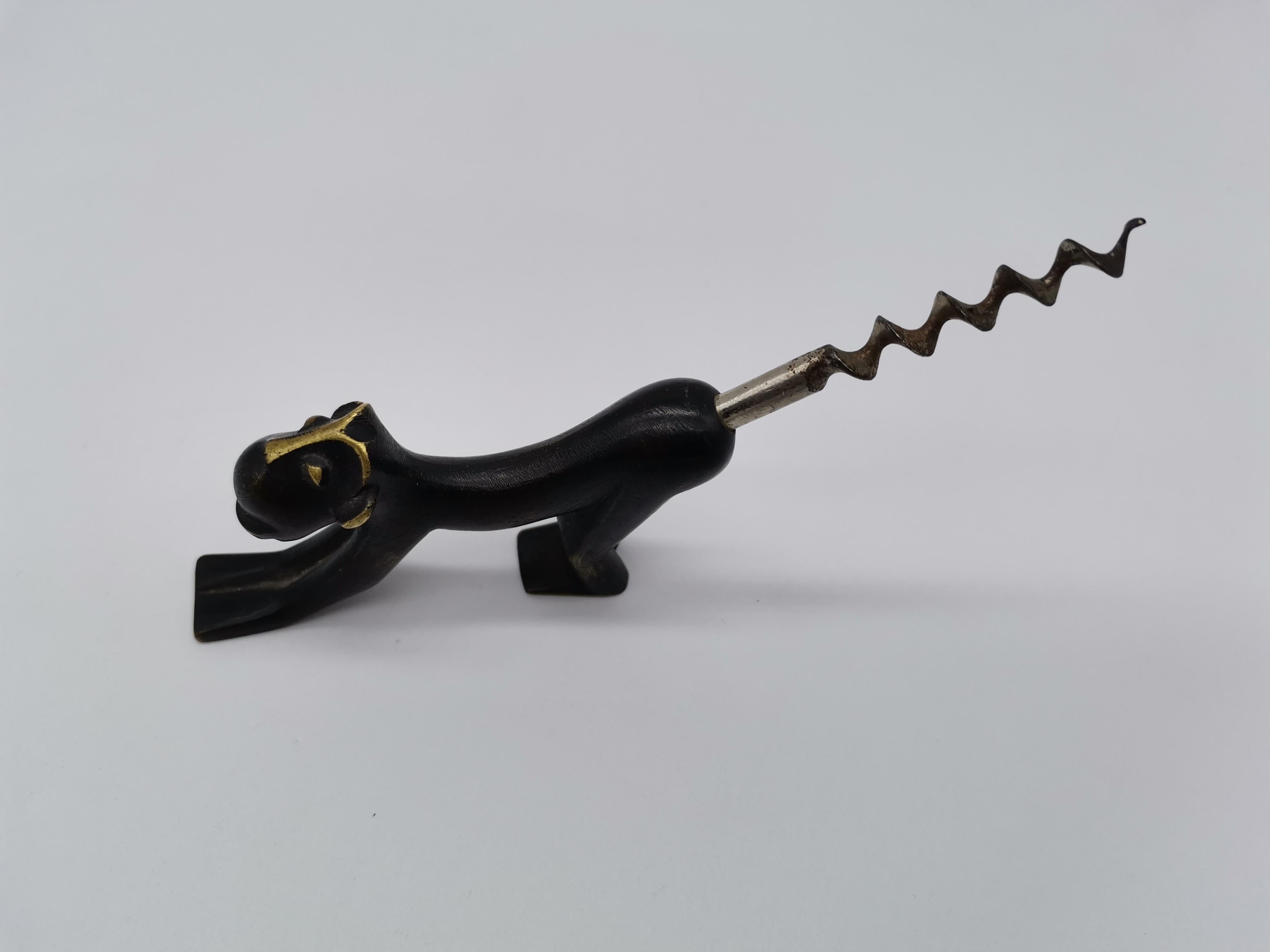 A partially blackened cork screw by Richard Rohac in the shape of an ape.